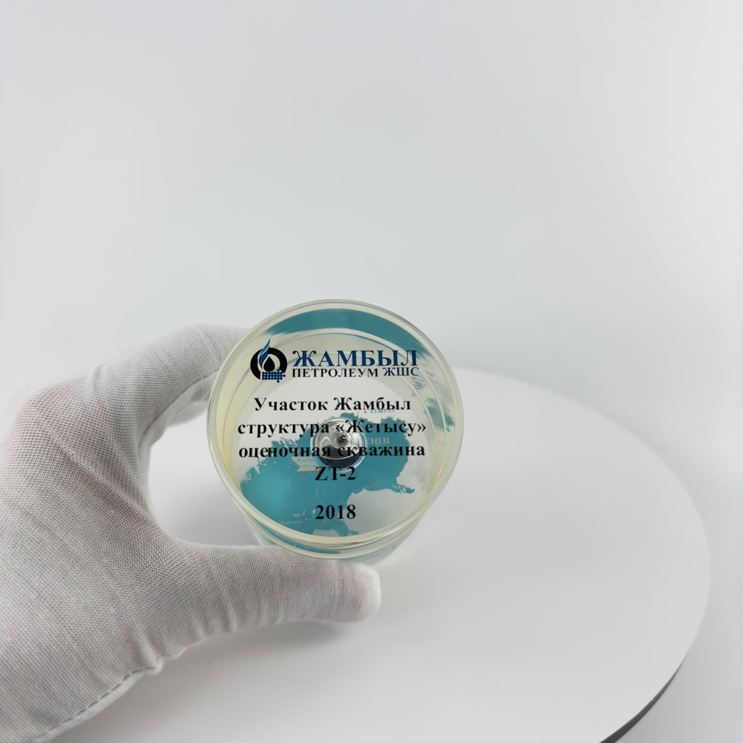 TRANSPARENT PAPER WEIGHT ENCAPSULATED WITH TEAR DROP OIL BOTTLE