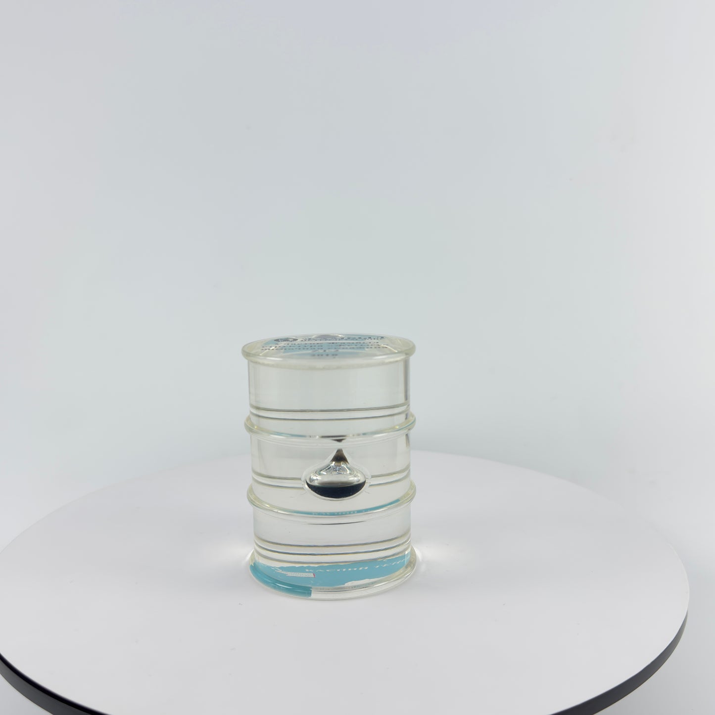 TRANSPARENT PAPER WEIGHT ENCAPSULATED WITH TEAR DROP OIL BOTTLE