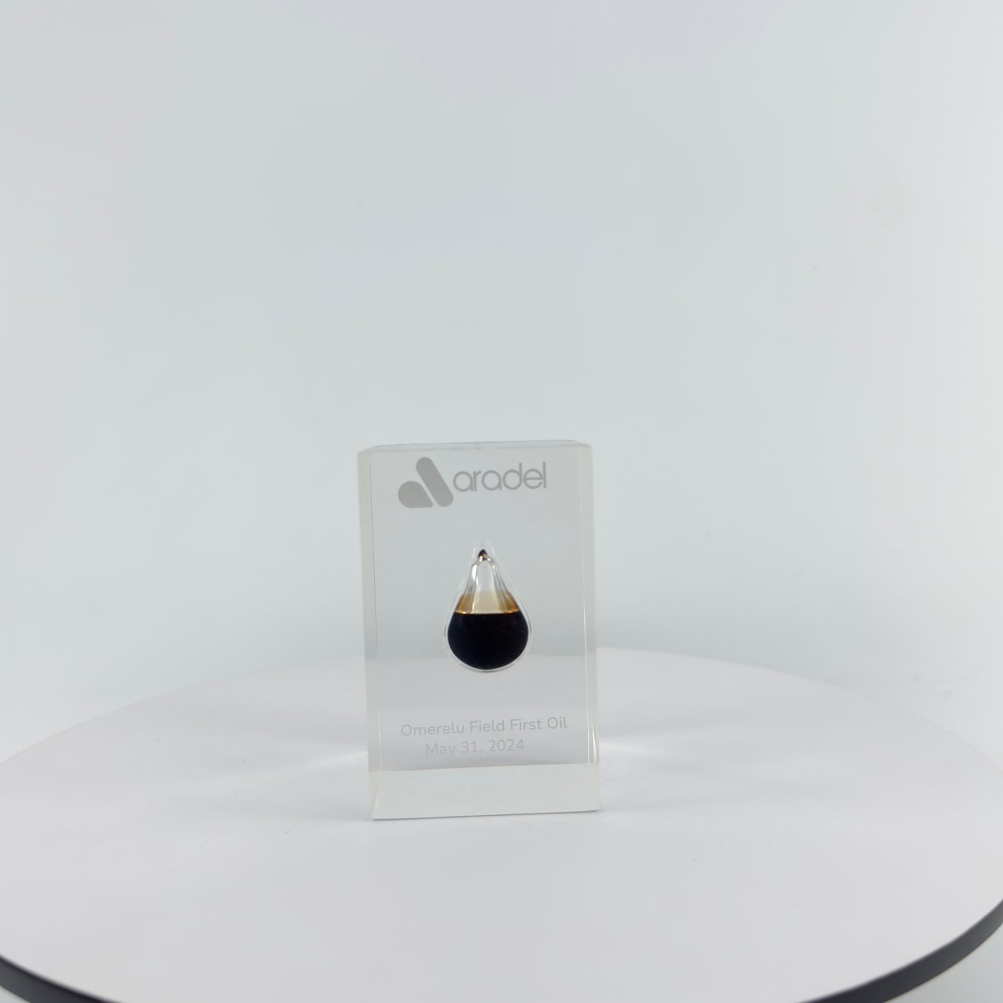 TRANSPARENT PAPER WEIGHT ENCAPSULATED WITH TEAR DROP OIL BOTTLE