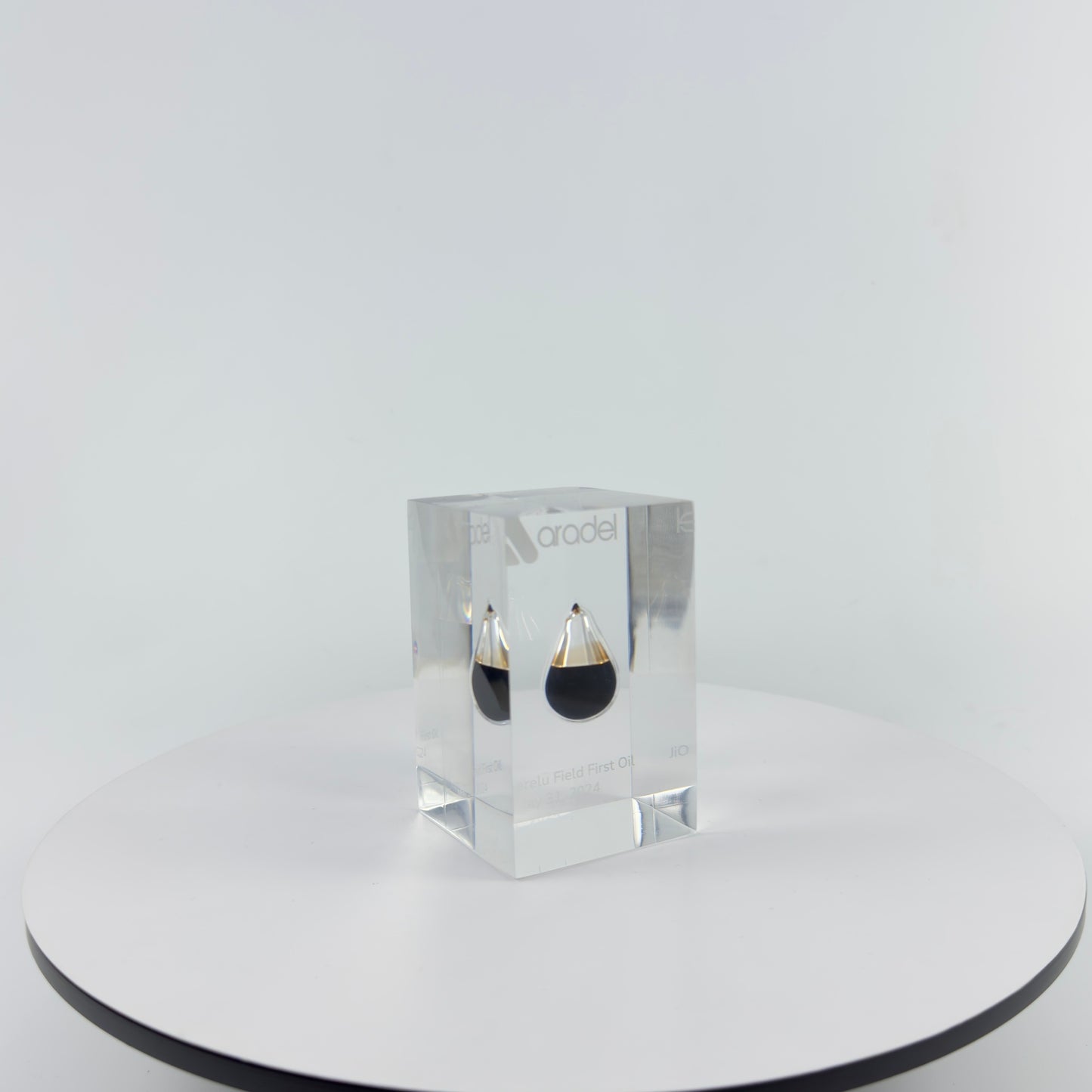 TRANSPARENT PAPER WEIGHT ENCAPSULATED WITH TEAR DROP OIL BOTTLE