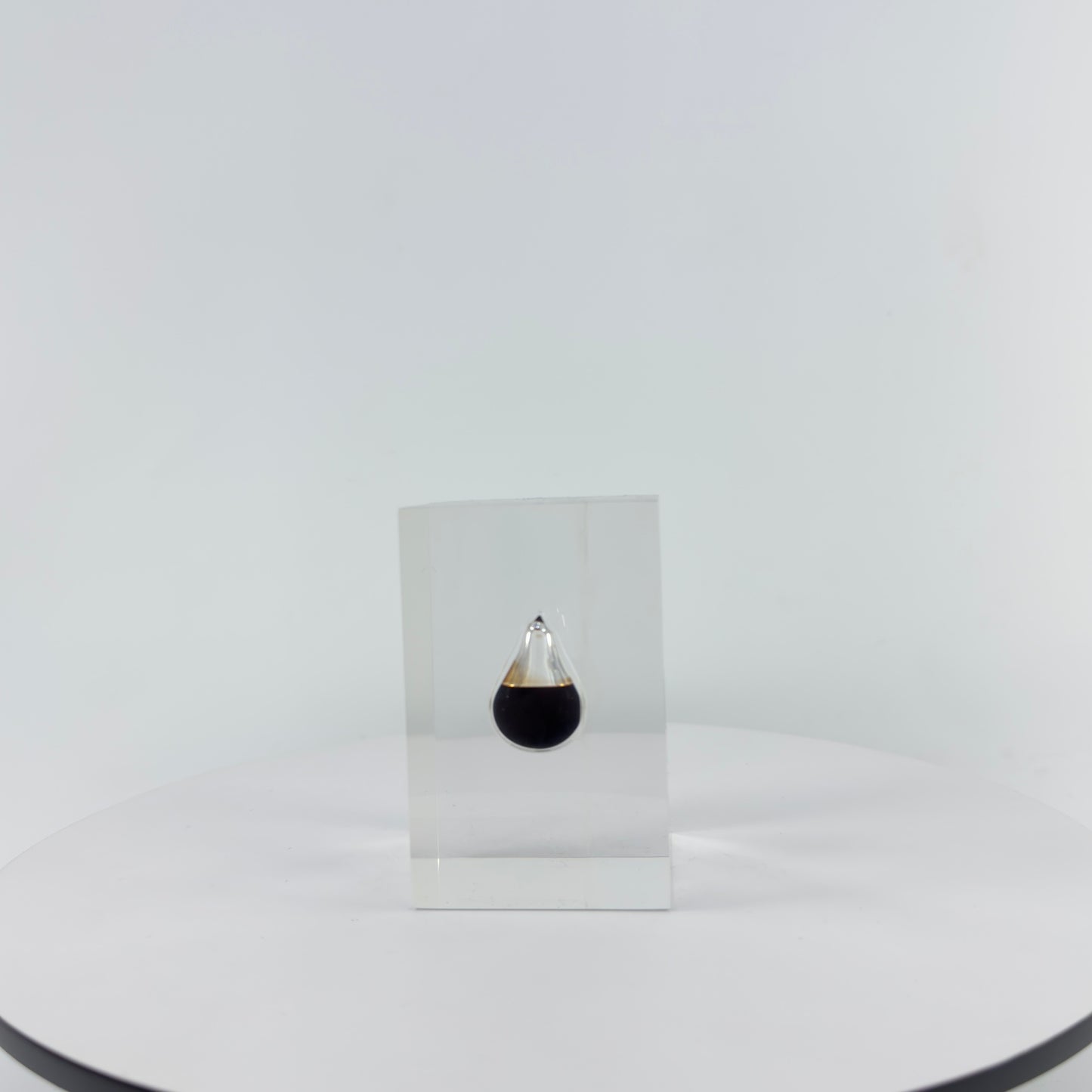 TRANSPARENT PAPER WEIGHT ENCAPSULATED WITH TEAR DROP OIL BOTTLE