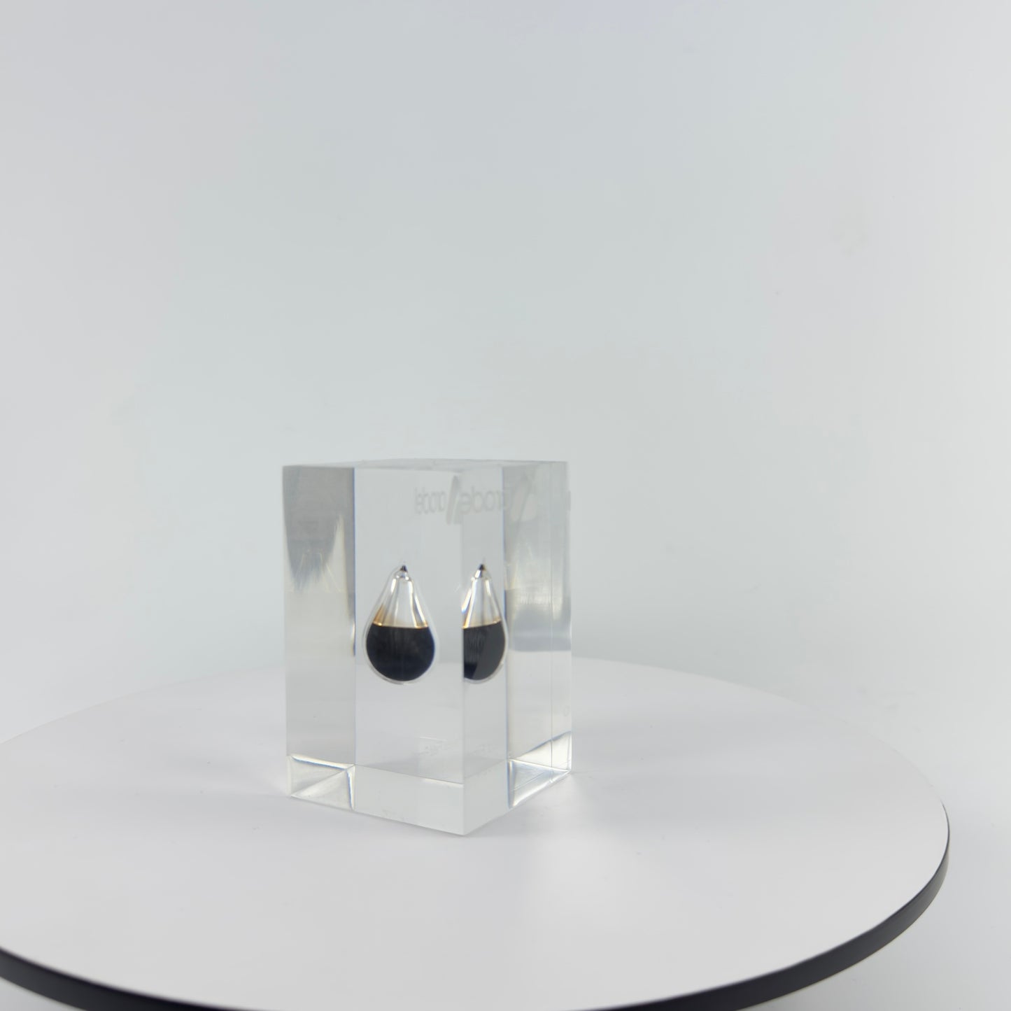 TRANSPARENT PAPER WEIGHT ENCAPSULATED WITH TEAR DROP OIL BOTTLE