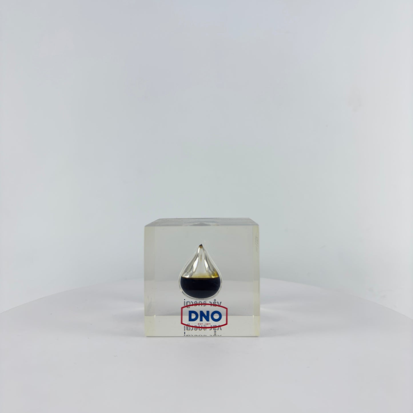 TRANSPARENT PAPER WEIGHT ENCAPSULATED WITH TEAR DROP OIL BOTTLE