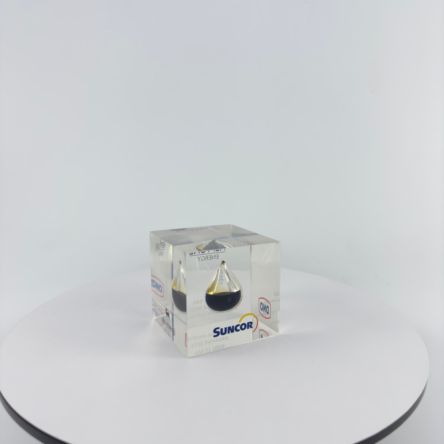 TRANSPARENT PAPER WEIGHT ENCAPSULATED WITH TEAR DROP OIL BOTTLE