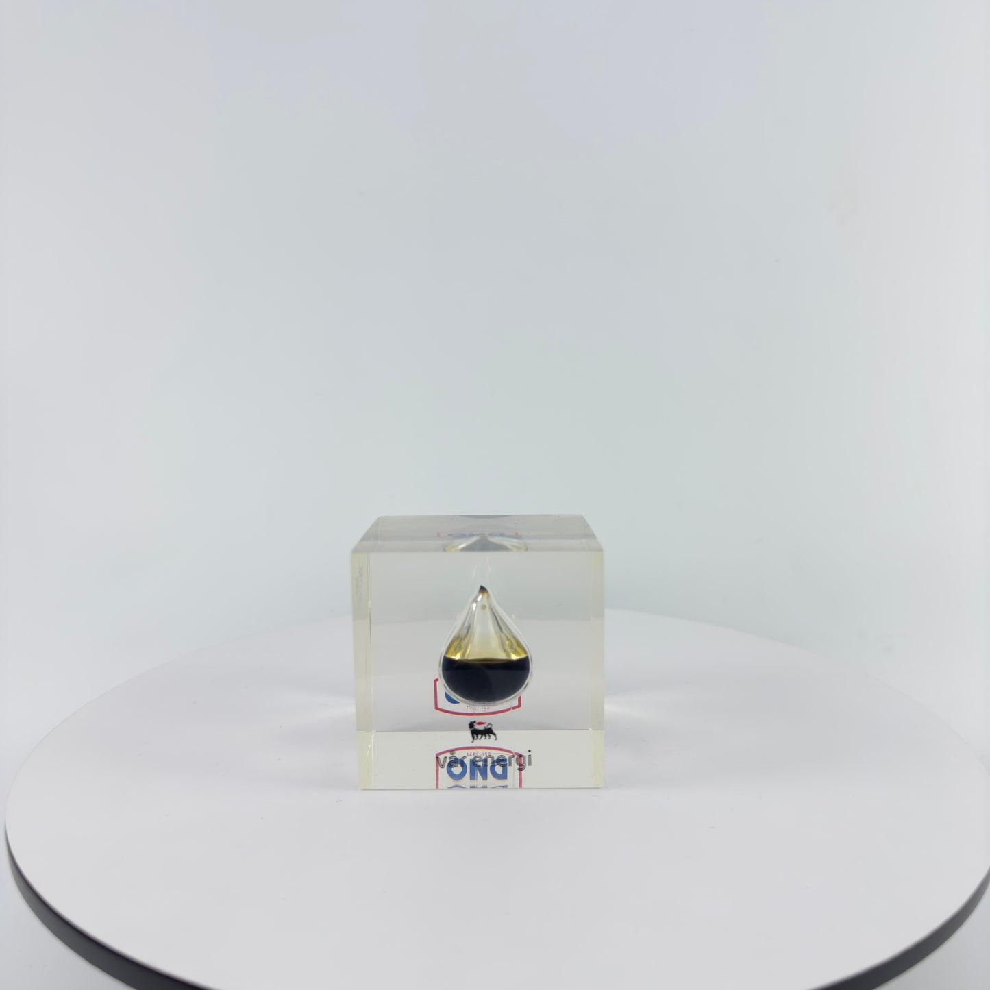TRANSPARENT PAPER WEIGHT ENCAPSULATED WITH TEAR DROP OIL BOTTLE