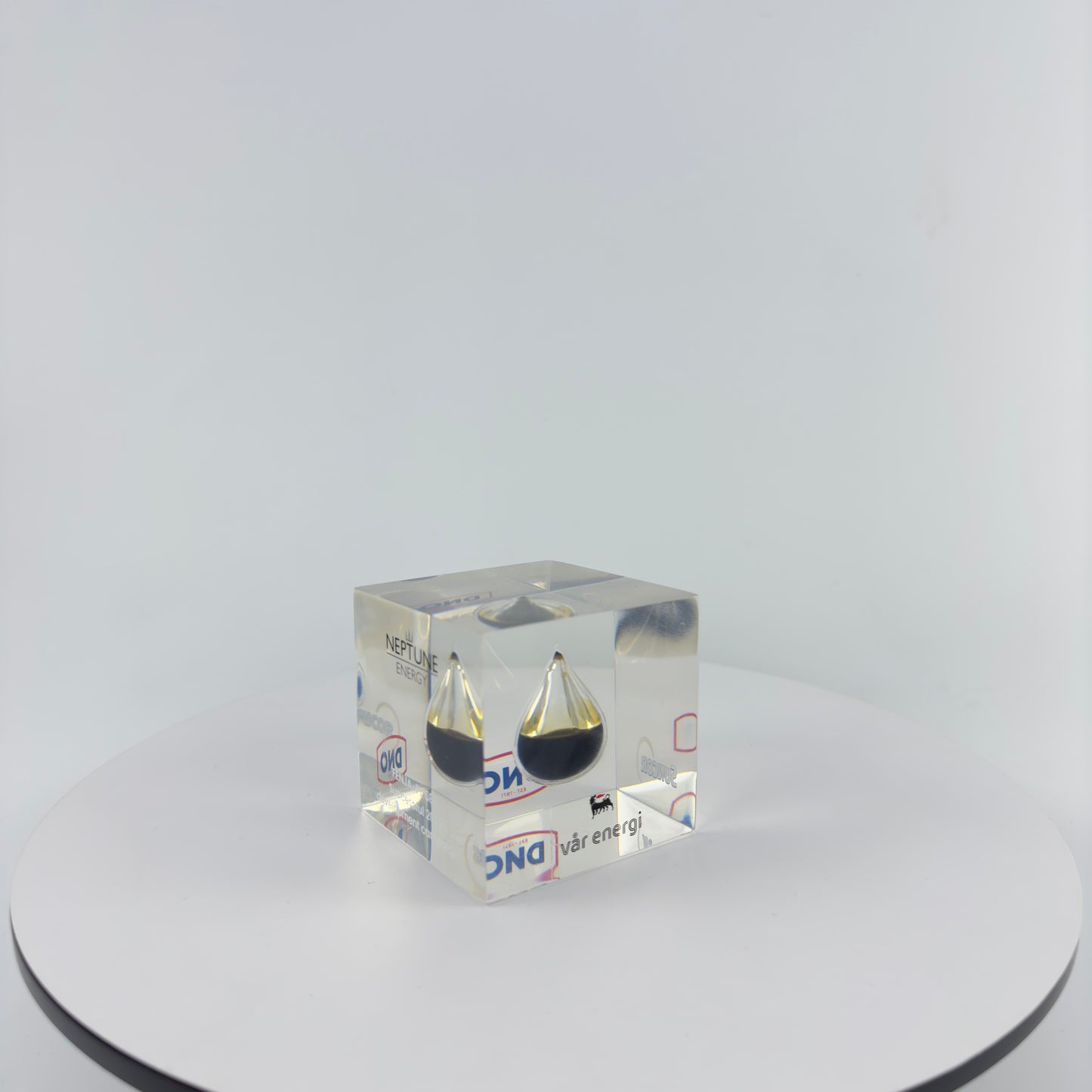 TRANSPARENT PAPER WEIGHT ENCAPSULATED WITH TEAR DROP OIL BOTTLE