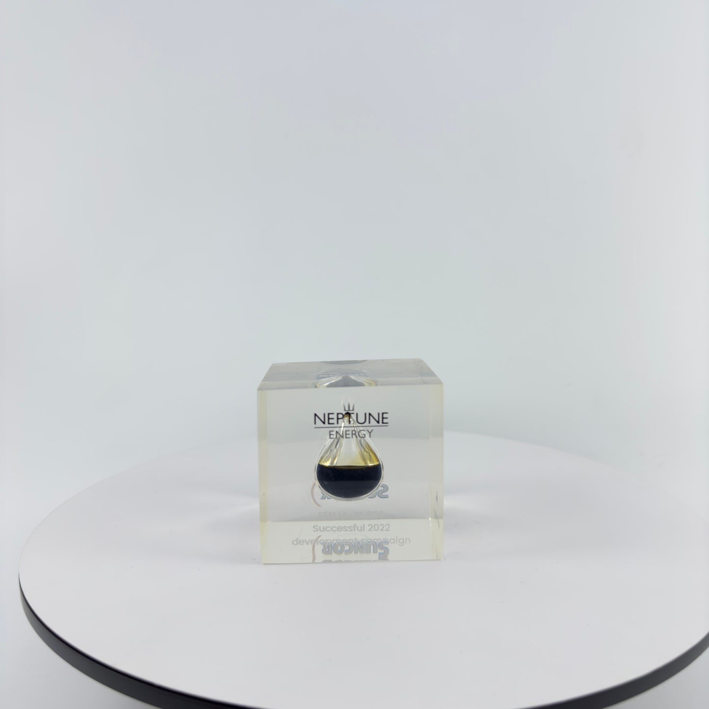 TRANSPARENT PAPER WEIGHT ENCAPSULATED WITH TEAR DROP OIL BOTTLE
