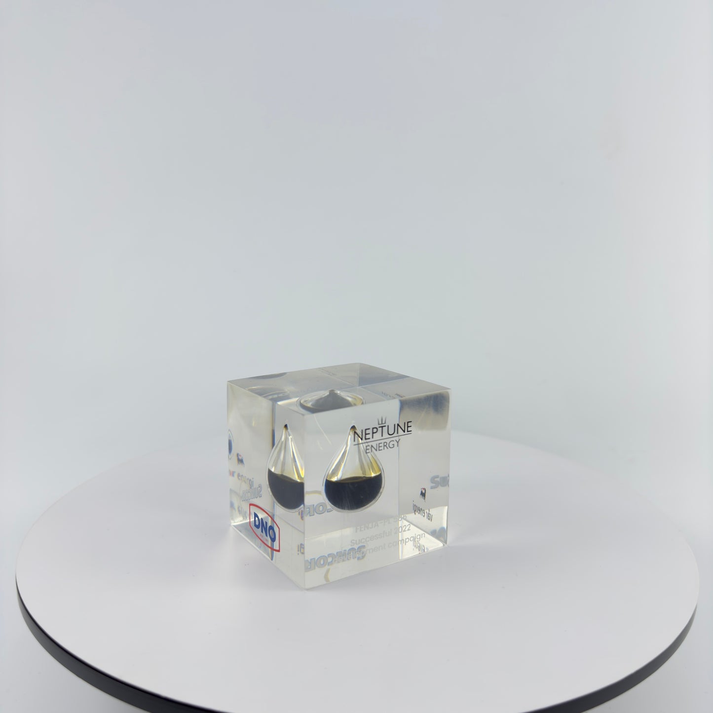 TRANSPARENT PAPER WEIGHT ENCAPSULATED WITH TEAR DROP OIL BOTTLE