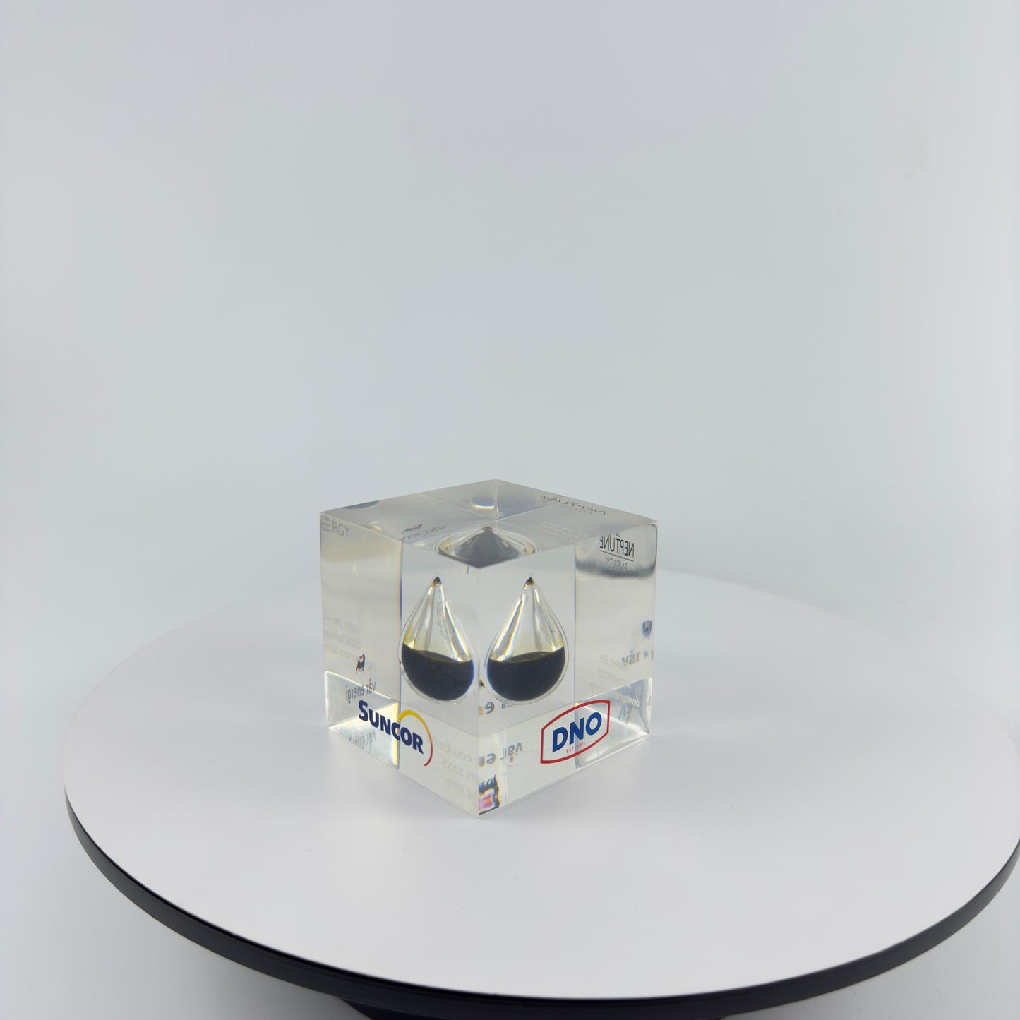 TRANSPARENT PAPER WEIGHT ENCAPSULATED WITH TEAR DROP OIL BOTTLE