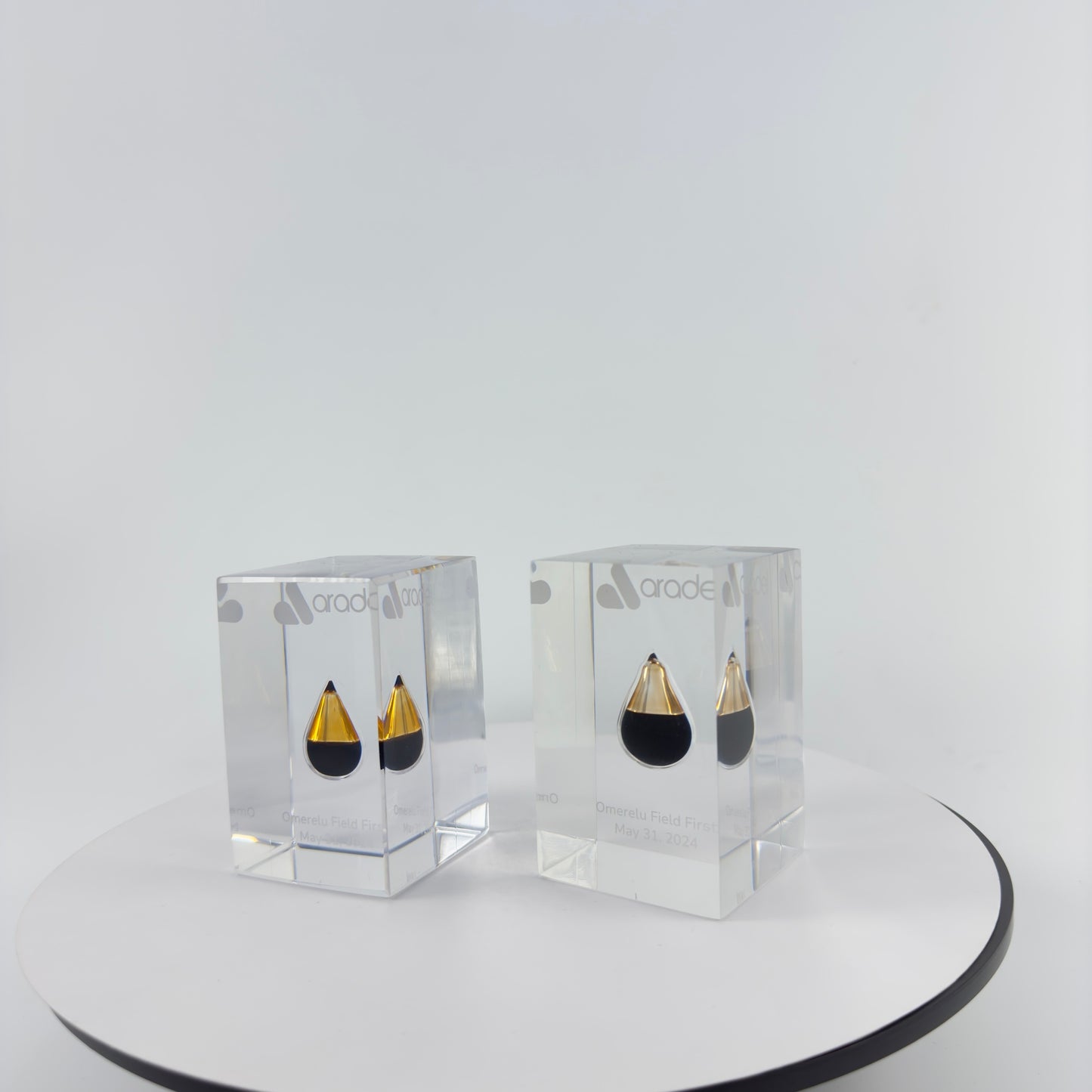 TRANSPARENT PAPER WEIGHT ENCAPSULATED WITH TEAR DROP OIL BOTTLE