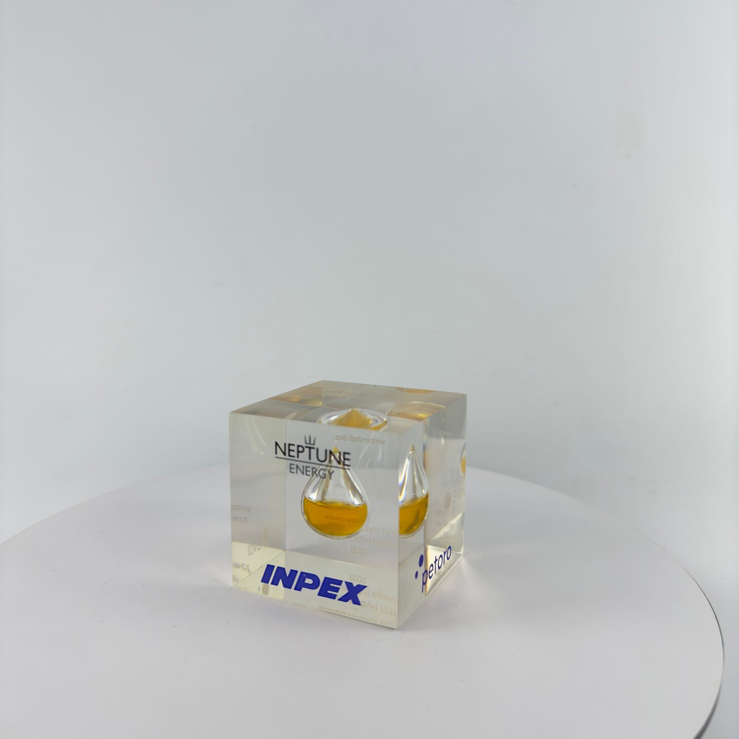 TRANSPARENT PAPER WEIGHT ENCAPSULATED WITH TEAR DROP OIL BOTTLE