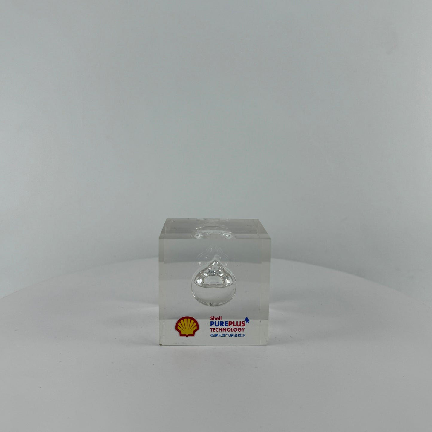 TRANSPARENT PAPER WEIGHT ENCAPSULATED WITH TEAR DROP OIL BOTTLE