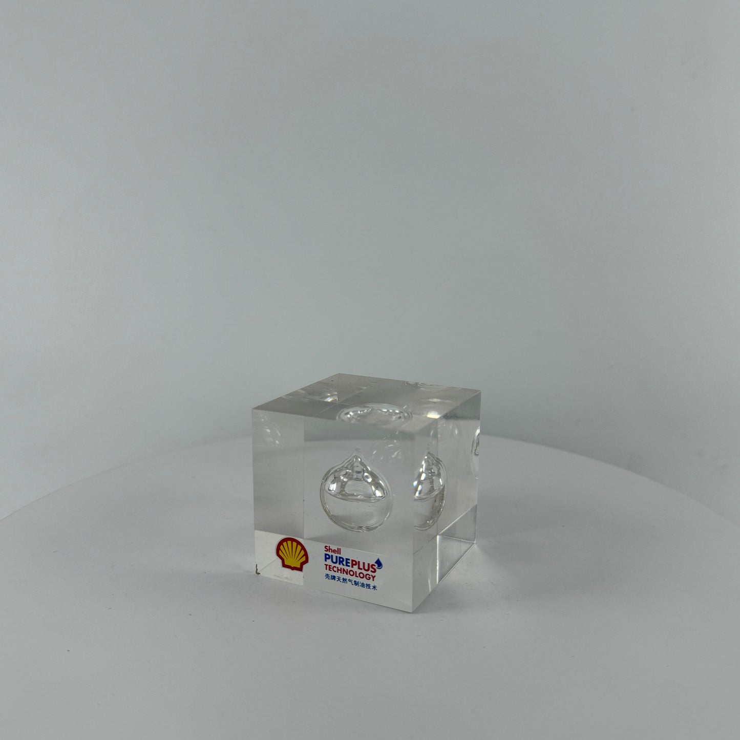 TRANSPARENT PAPER WEIGHT ENCAPSULATED WITH TEAR DROP OIL BOTTLE