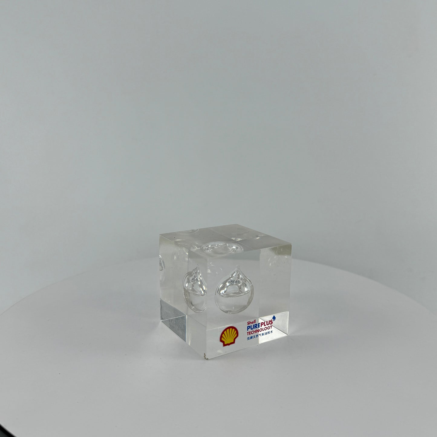 TRANSPARENT PAPER WEIGHT ENCAPSULATED WITH TEAR DROP OIL BOTTLE