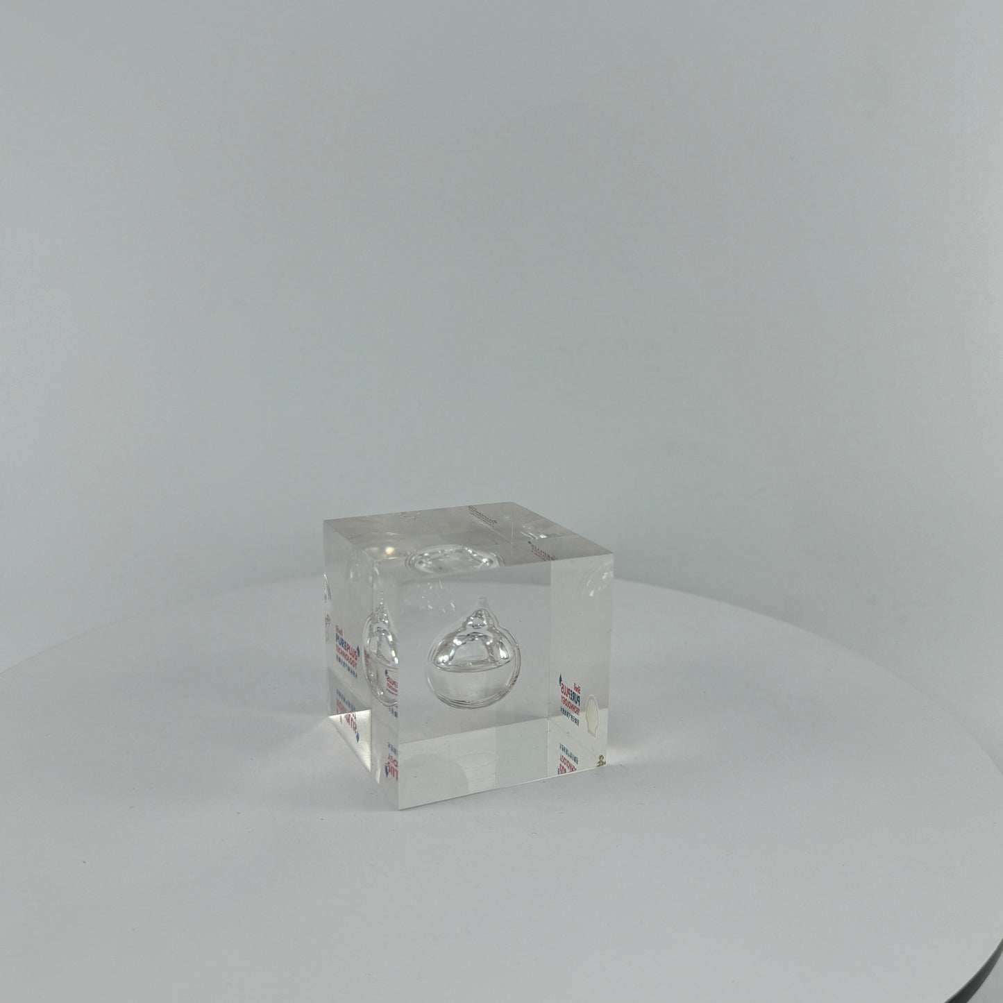 TRANSPARENT PAPER WEIGHT ENCAPSULATED WITH TEAR DROP OIL BOTTLE