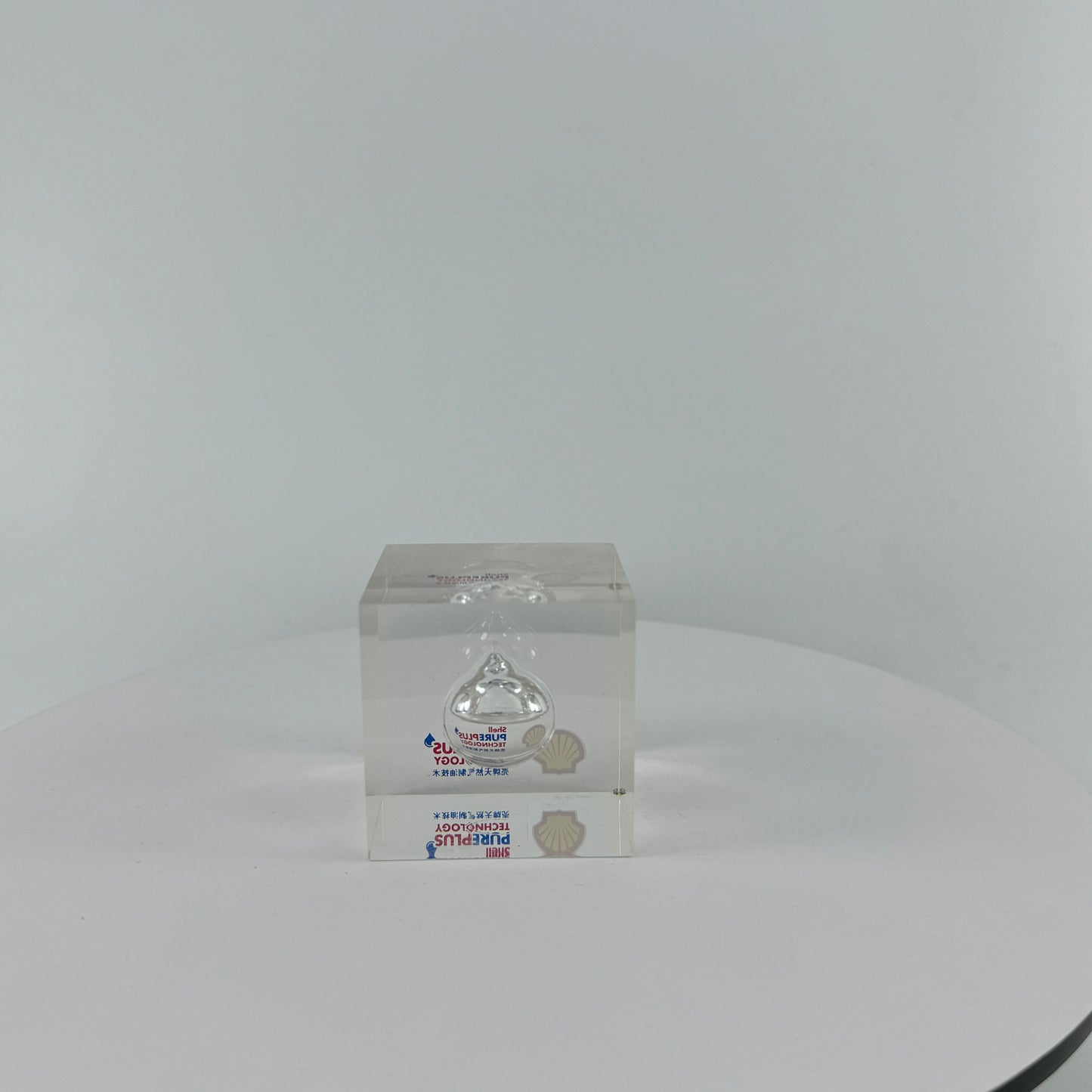 TRANSPARENT PAPER WEIGHT ENCAPSULATED WITH TEAR DROP OIL BOTTLE