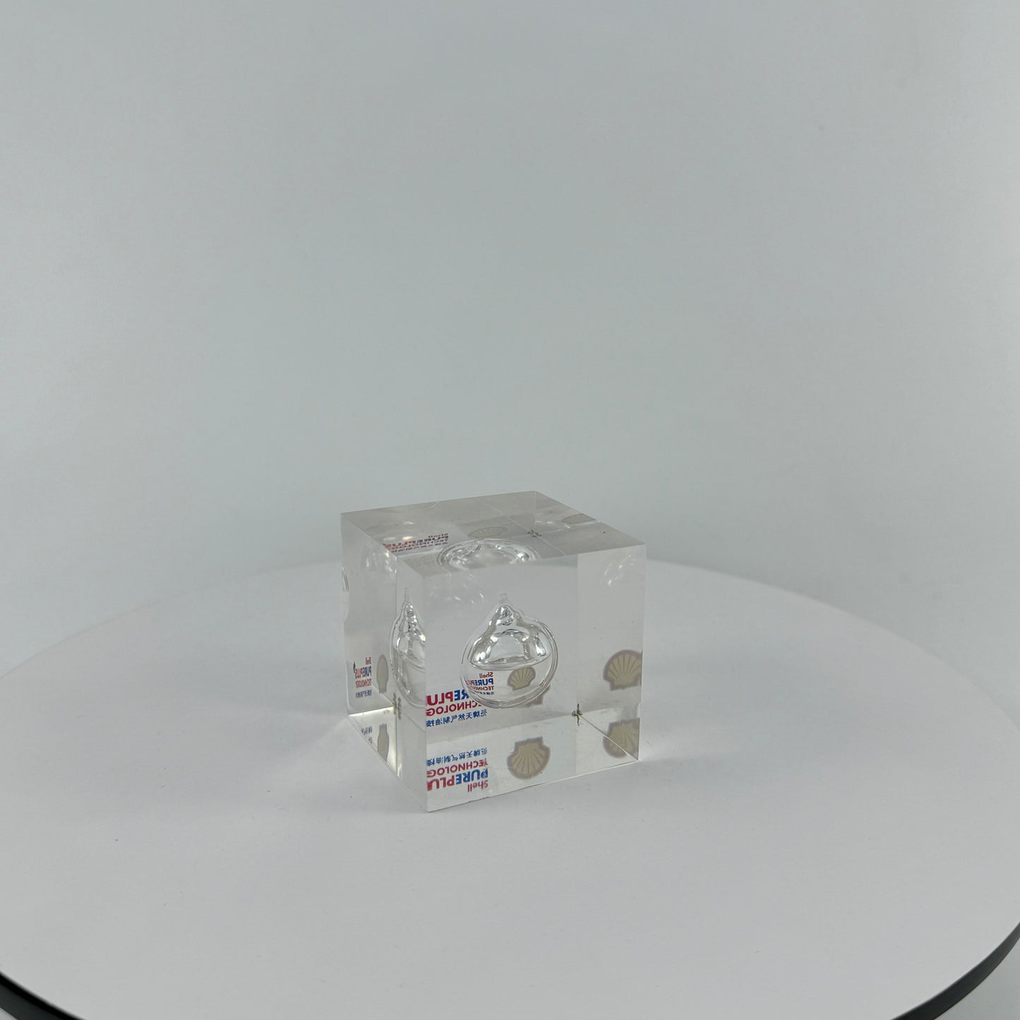 TRANSPARENT PAPER WEIGHT ENCAPSULATED WITH TEAR DROP OIL BOTTLE