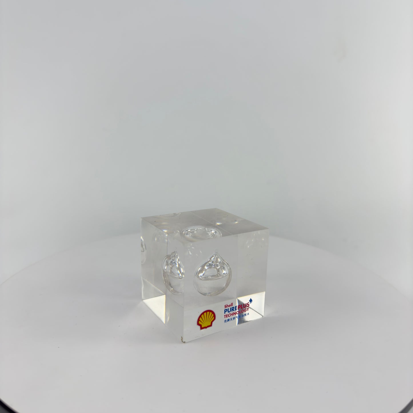 TRANSPARENT PAPER WEIGHT ENCAPSULATED WITH TEAR DROP OIL BOTTLE