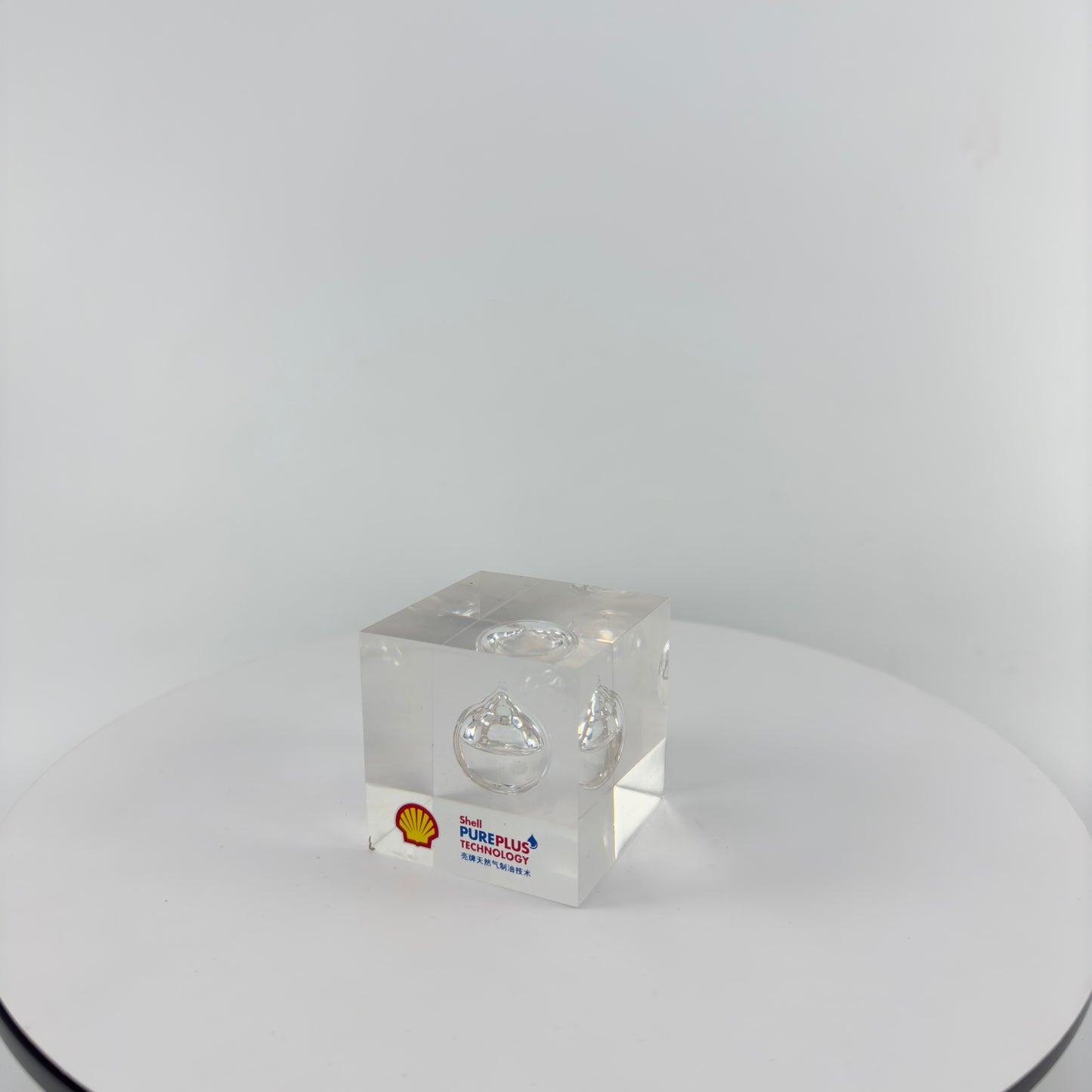 TRANSPARENT PAPER WEIGHT ENCAPSULATED WITH TEAR DROP OIL BOTTLE