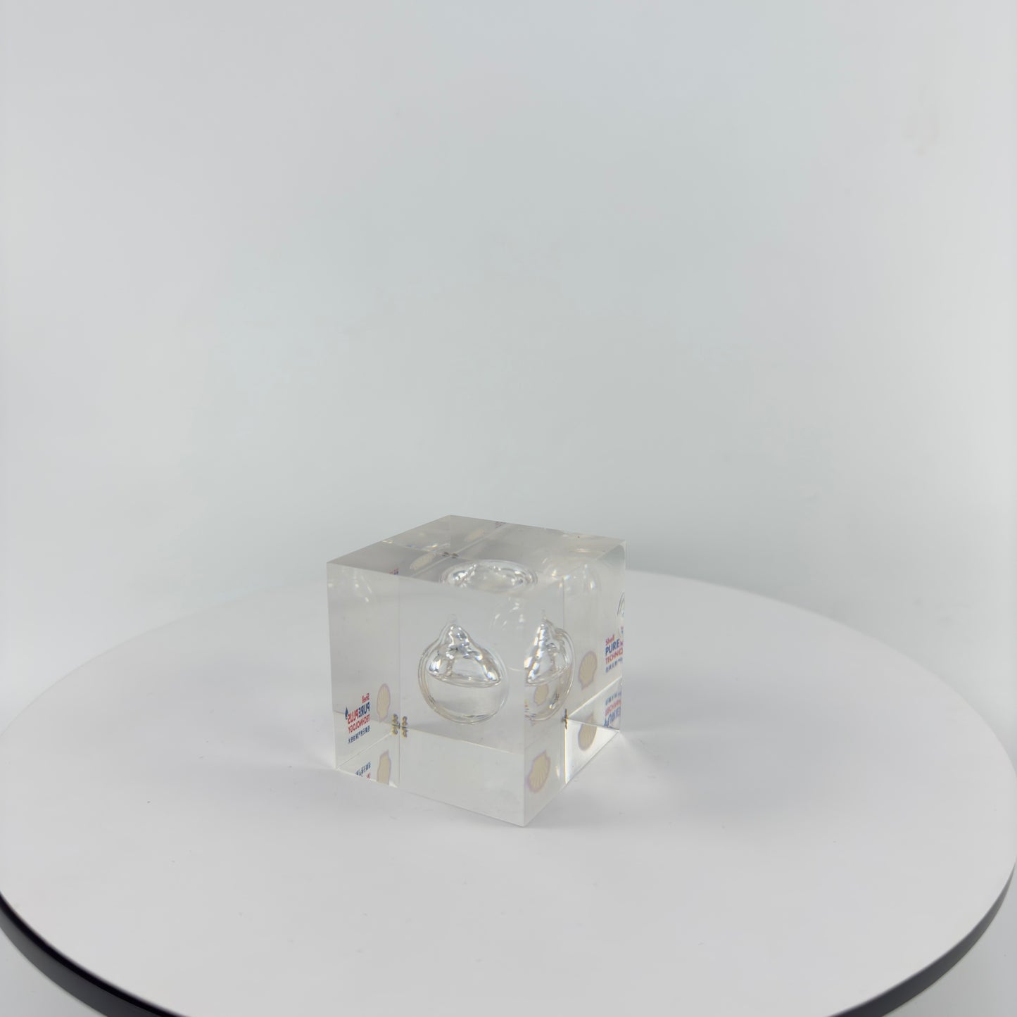 TRANSPARENT PAPER WEIGHT ENCAPSULATED WITH TEAR DROP OIL BOTTLE