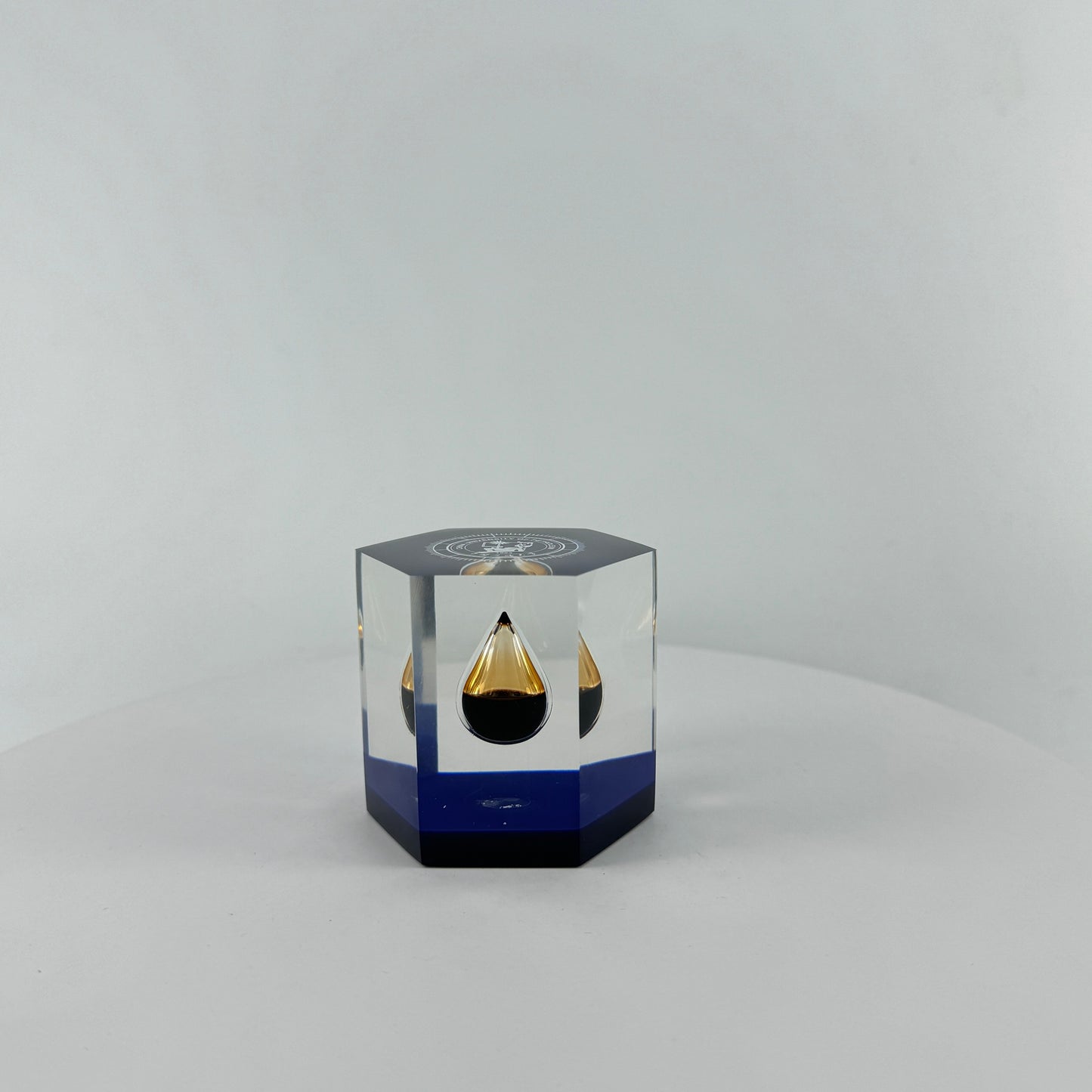 TRANSPARENT PAPER WEIGHT ENCAPSULATED WITH TEAR DROP OIL BOTTLE