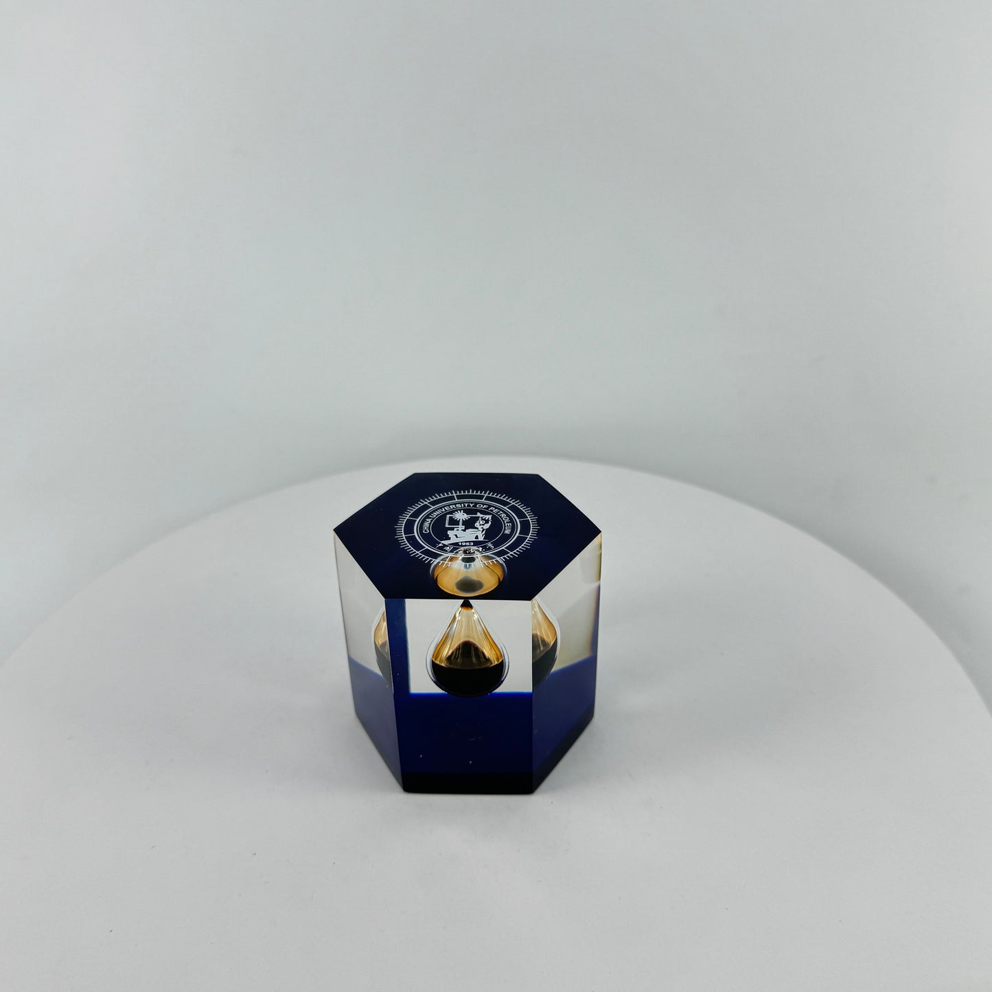 TRANSPARENT PAPER WEIGHT ENCAPSULATED WITH TEAR DROP OIL BOTTLE