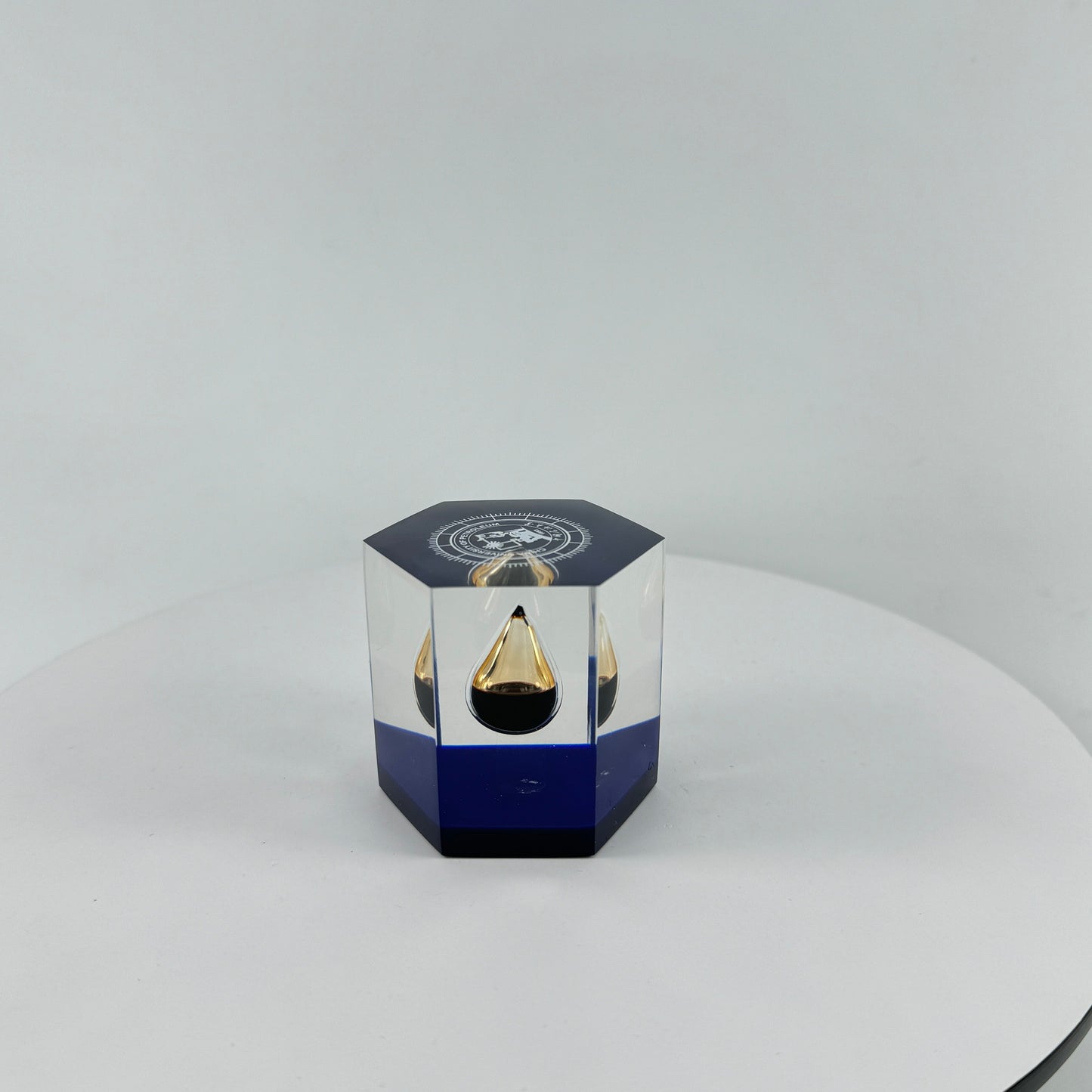 TRANSPARENT PAPER WEIGHT ENCAPSULATED WITH TEAR DROP OIL BOTTLE