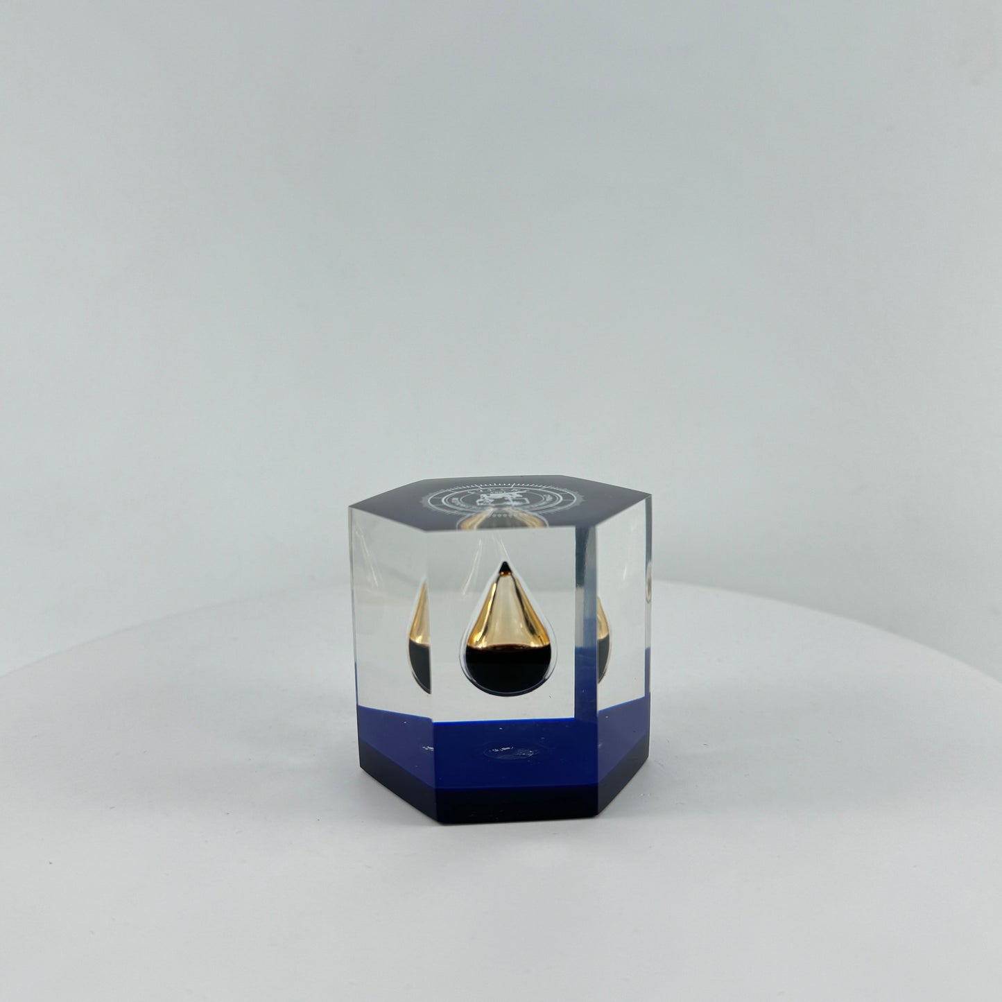 TRANSPARENT PAPER WEIGHT ENCAPSULATED WITH TEAR DROP OIL BOTTLE