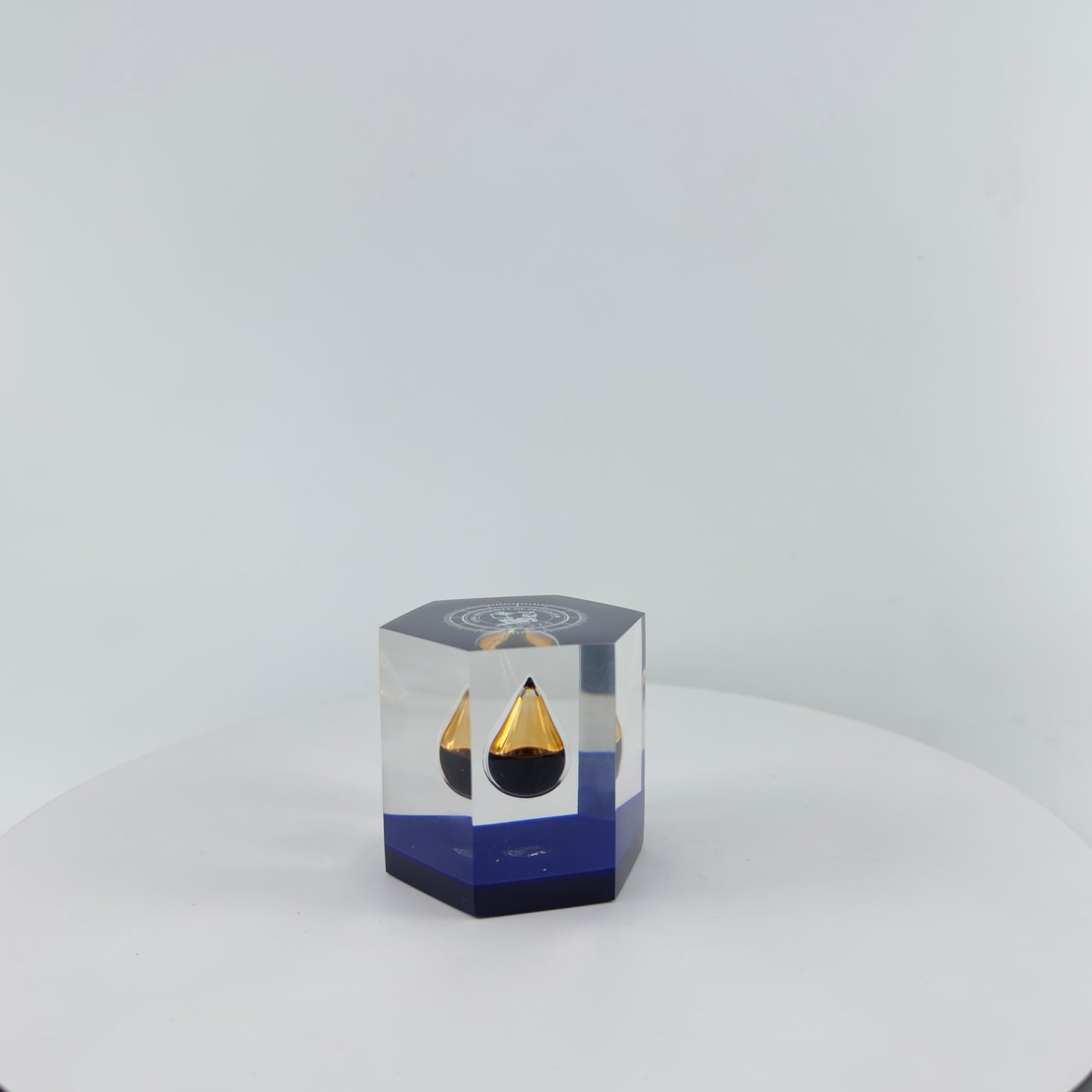 TRANSPARENT PAPER WEIGHT ENCAPSULATED WITH TEAR DROP OIL BOTTLE