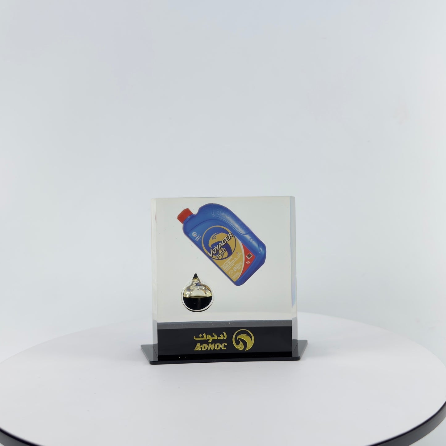TRANSPARENT PAPER WEIGHT ENCAPSULATED WITH TEAR DROP OIL BOTTLE