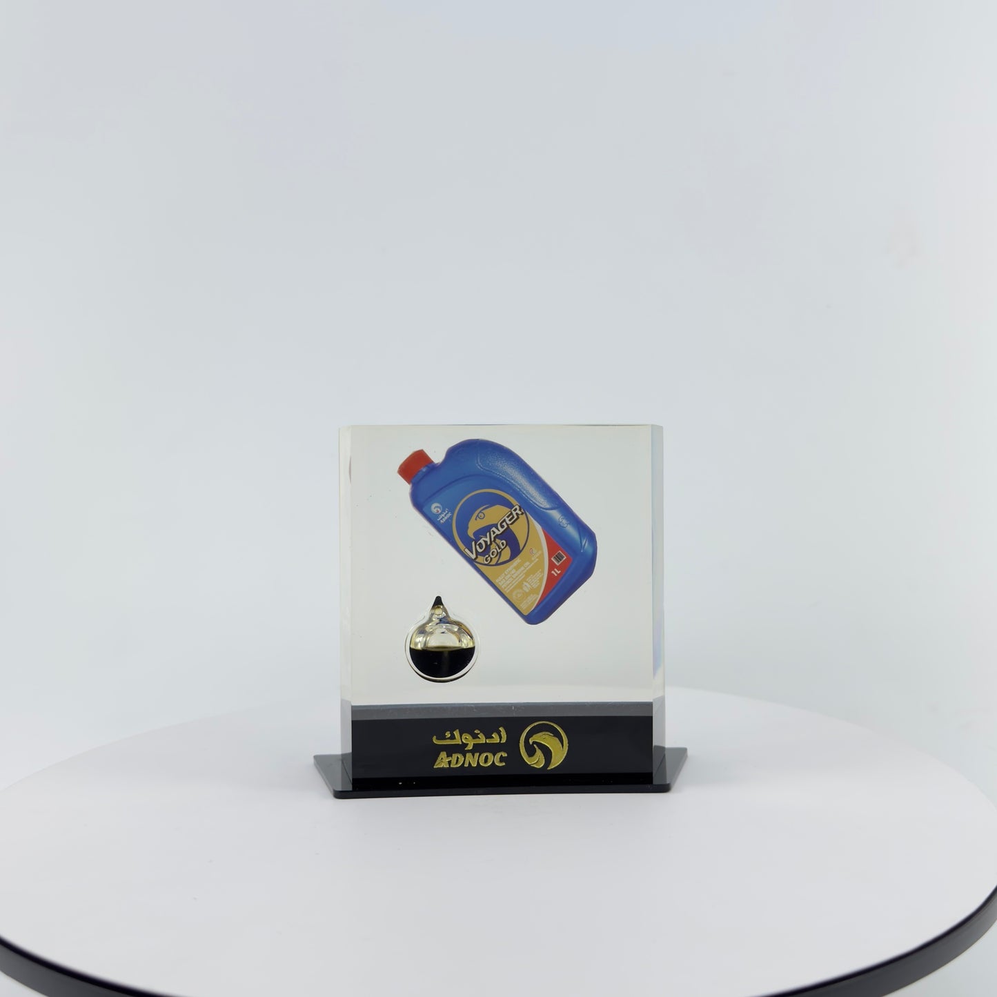 TRANSPARENT PAPER WEIGHT ENCAPSULATED WITH TEAR DROP OIL BOTTLE