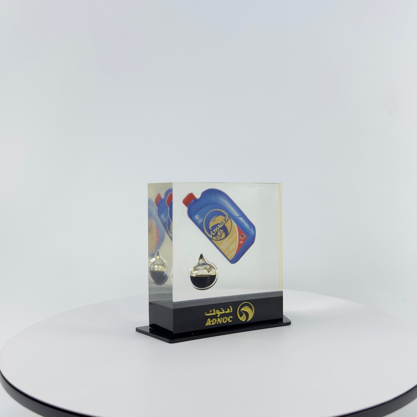 TRANSPARENT PAPER WEIGHT ENCAPSULATED WITH TEAR DROP OIL BOTTLE