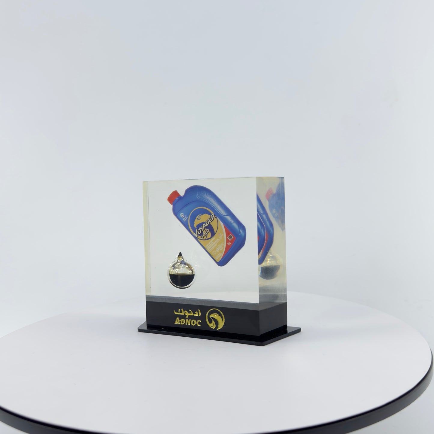 TRANSPARENT PAPER WEIGHT ENCAPSULATED WITH TEAR DROP OIL BOTTLE