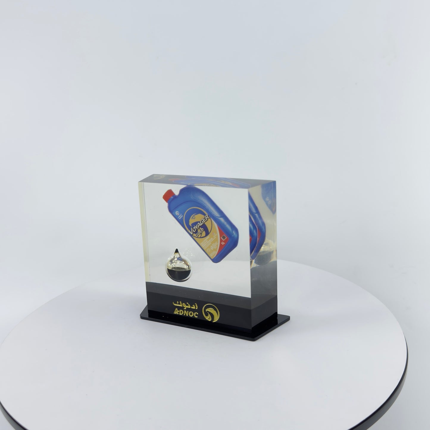 TRANSPARENT PAPER WEIGHT ENCAPSULATED WITH TEAR DROP OIL BOTTLE