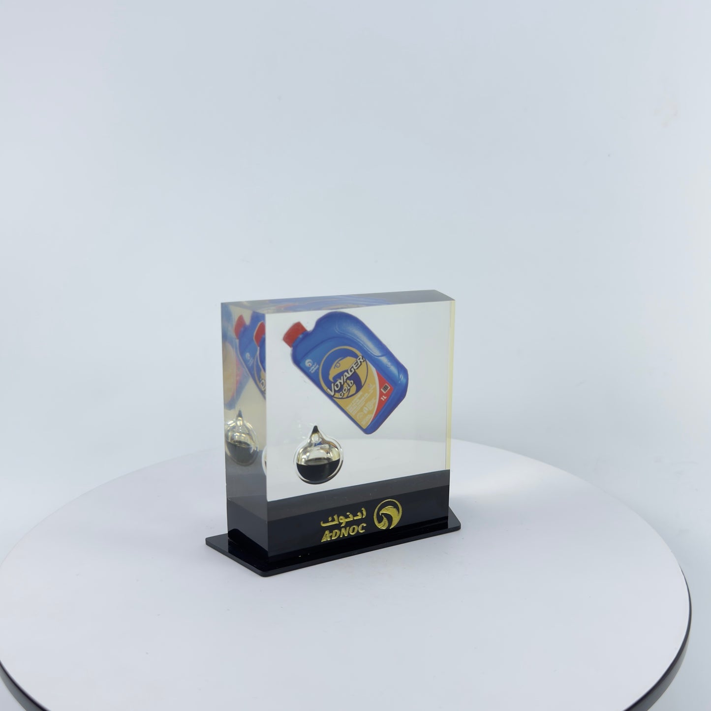 TRANSPARENT PAPER WEIGHT ENCAPSULATED WITH TEAR DROP OIL BOTTLE