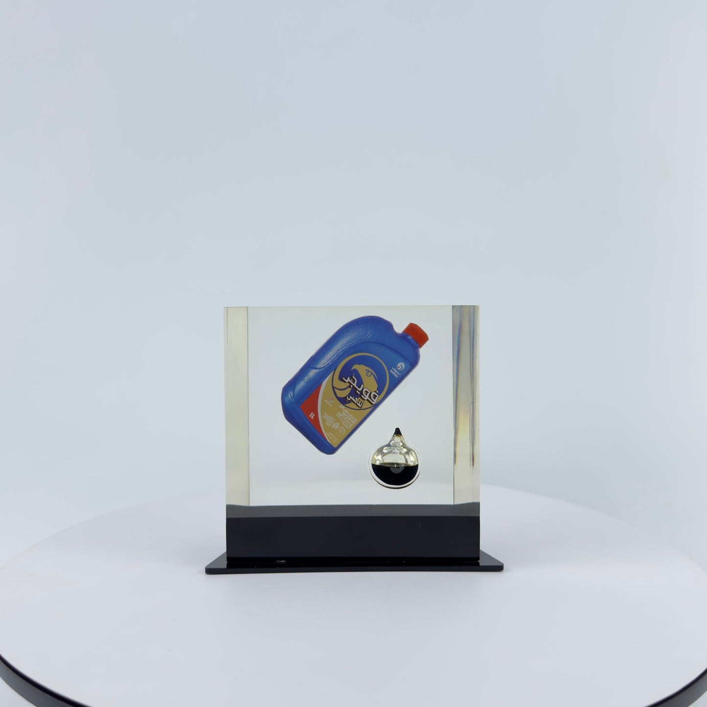 TRANSPARENT PAPER WEIGHT ENCAPSULATED WITH TEAR DROP OIL BOTTLE
