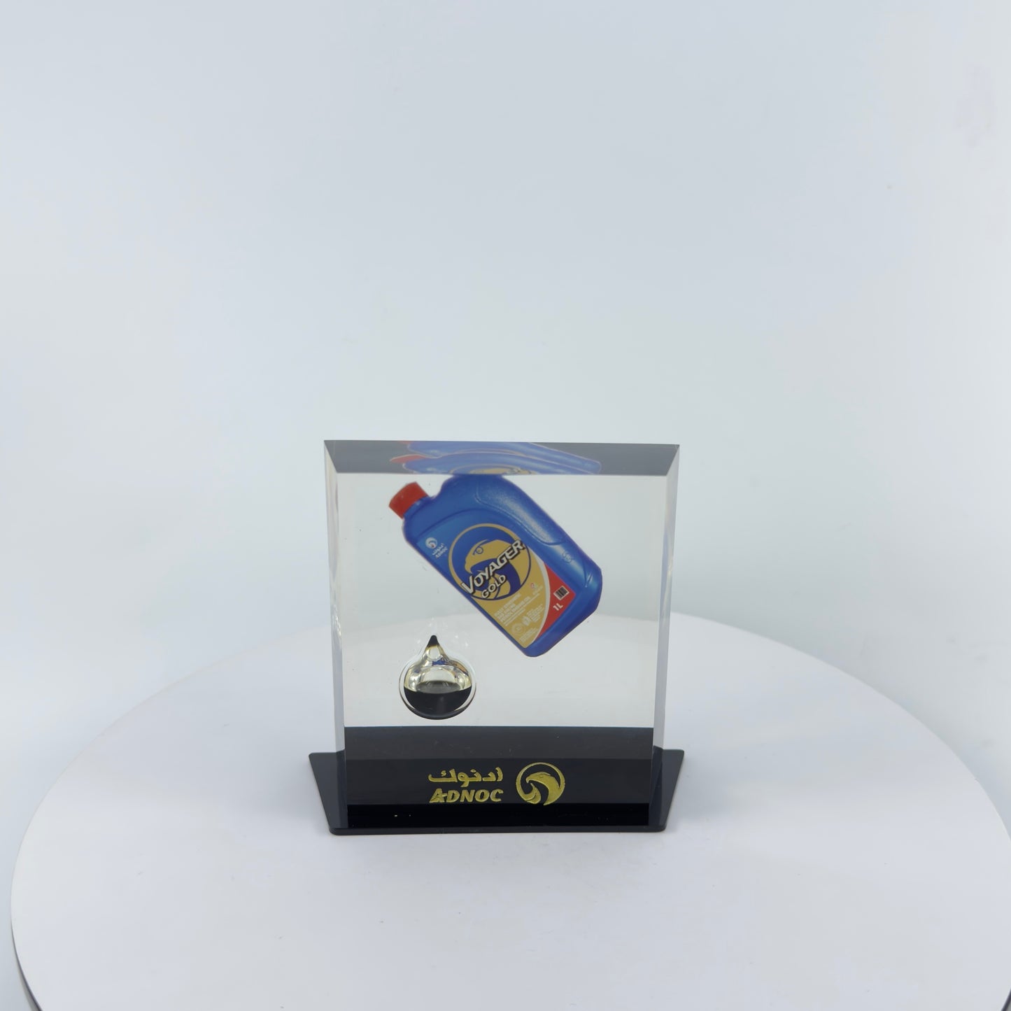 TRANSPARENT PAPER WEIGHT ENCAPSULATED WITH TEAR DROP OIL BOTTLE