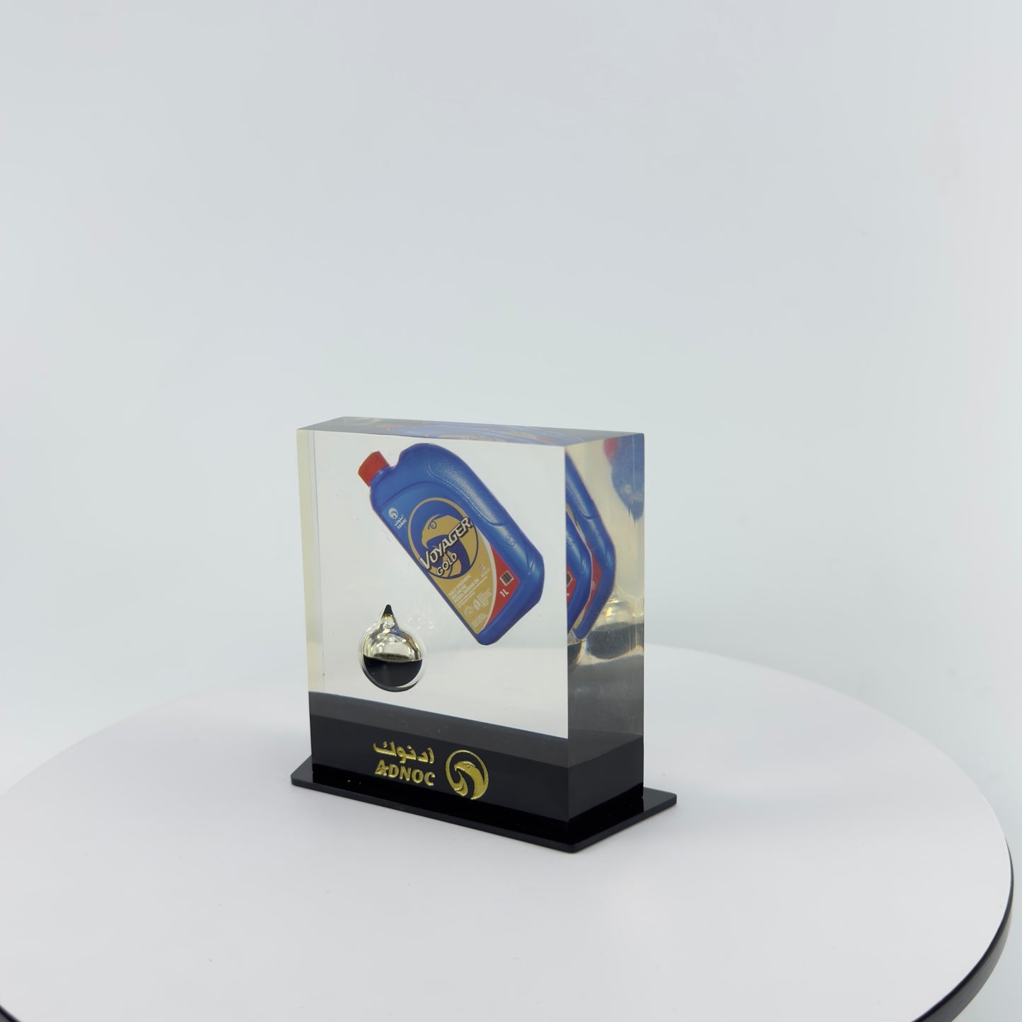 TRANSPARENT PAPER WEIGHT ENCAPSULATED WITH TEAR DROP OIL BOTTLE