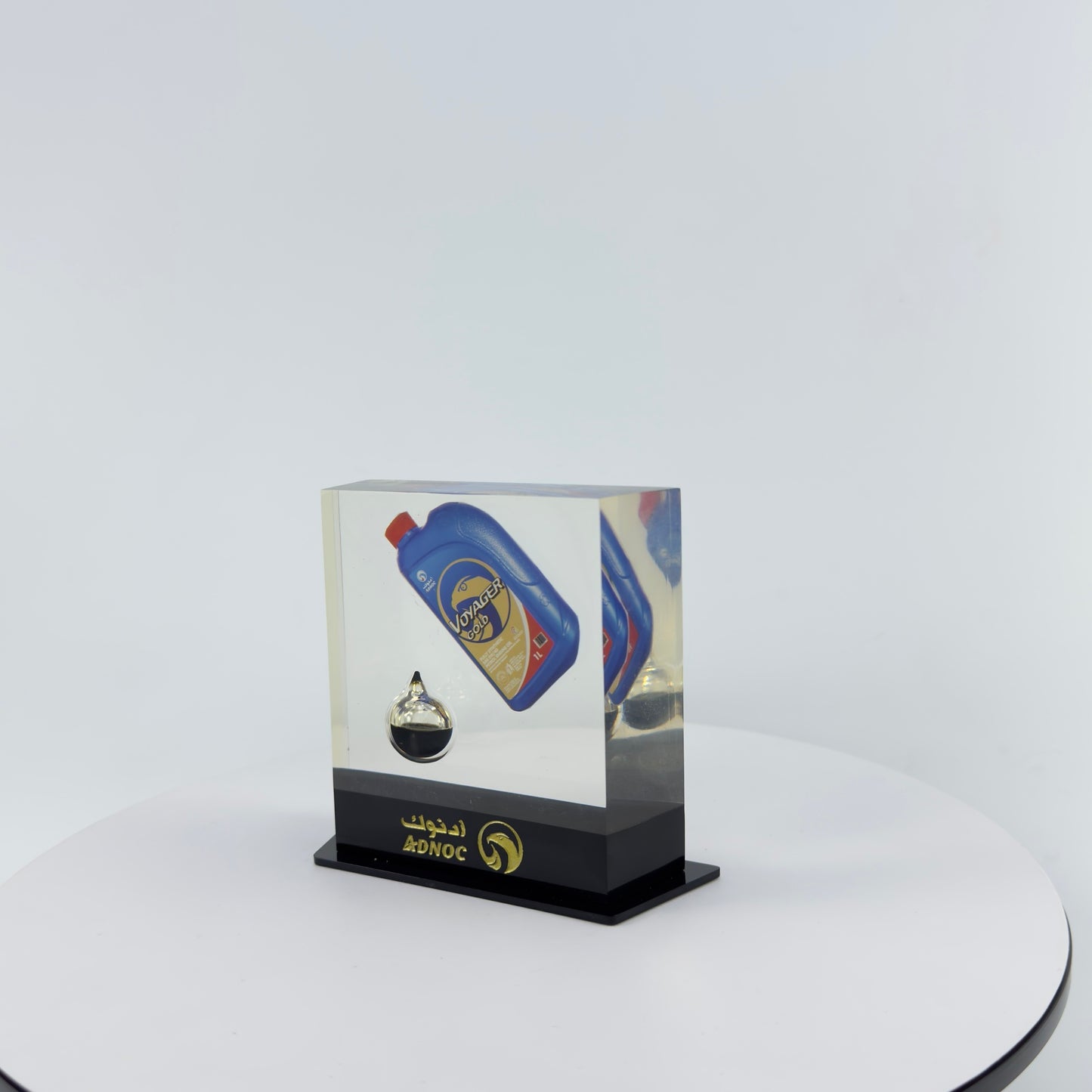 TRANSPARENT PAPER WEIGHT ENCAPSULATED WITH TEAR DROP OIL BOTTLE
