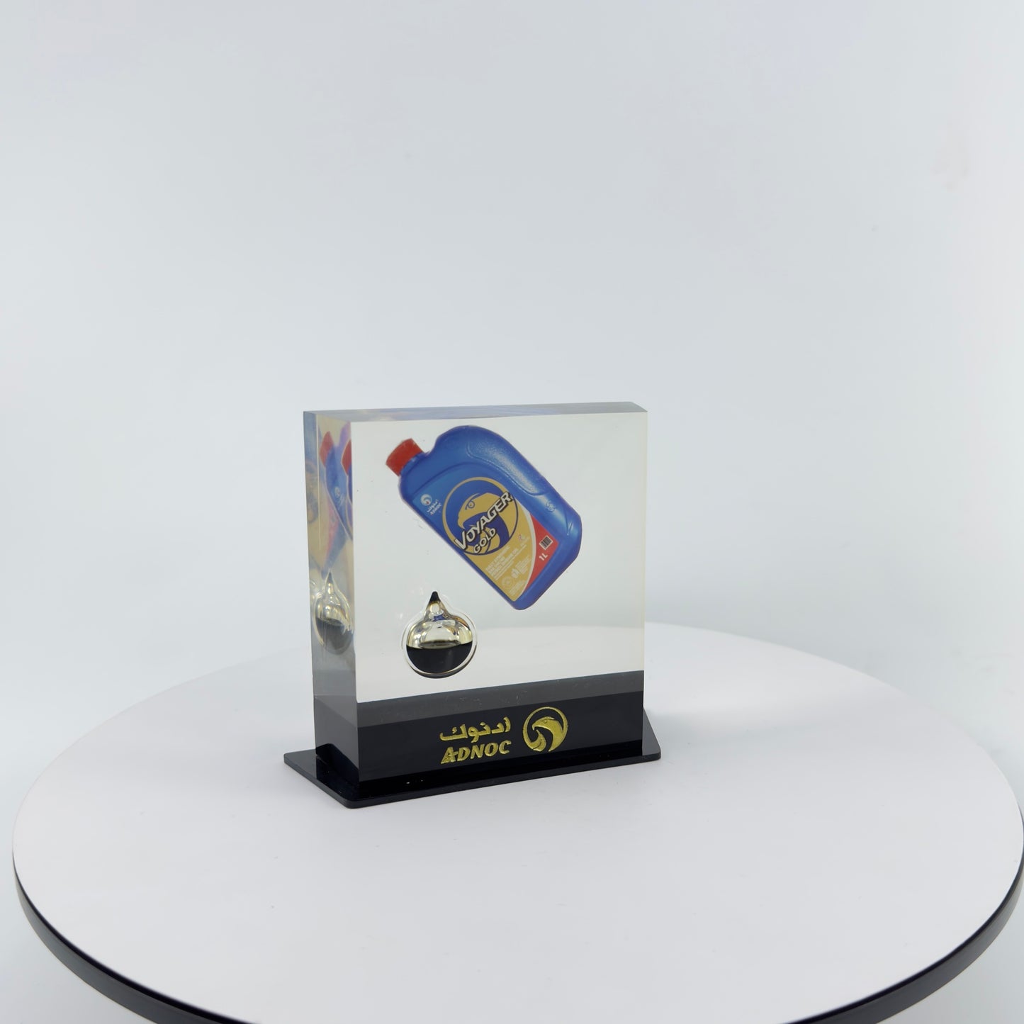TRANSPARENT PAPER WEIGHT ENCAPSULATED WITH TEAR DROP OIL BOTTLE