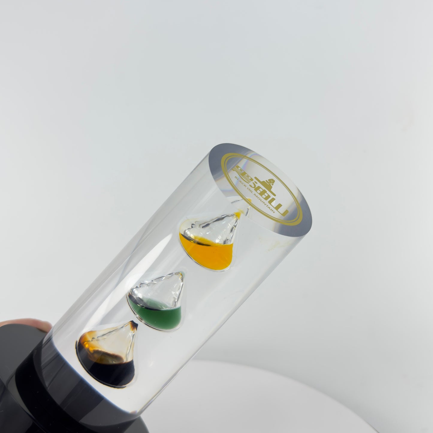 TRANSPARENT PAPER WEIGHT ENCAPSULATED WITH 3 TEAR DROP OIL BOTTLE