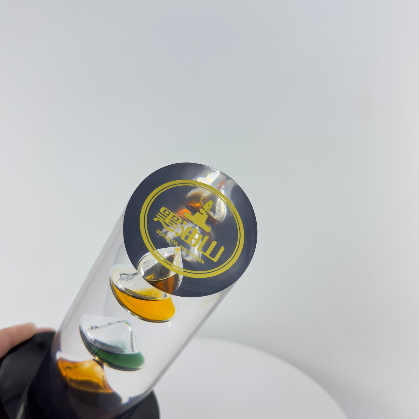 TRANSPARENT PAPER WEIGHT ENCAPSULATED WITH 3 TEAR DROP OIL BOTTLE