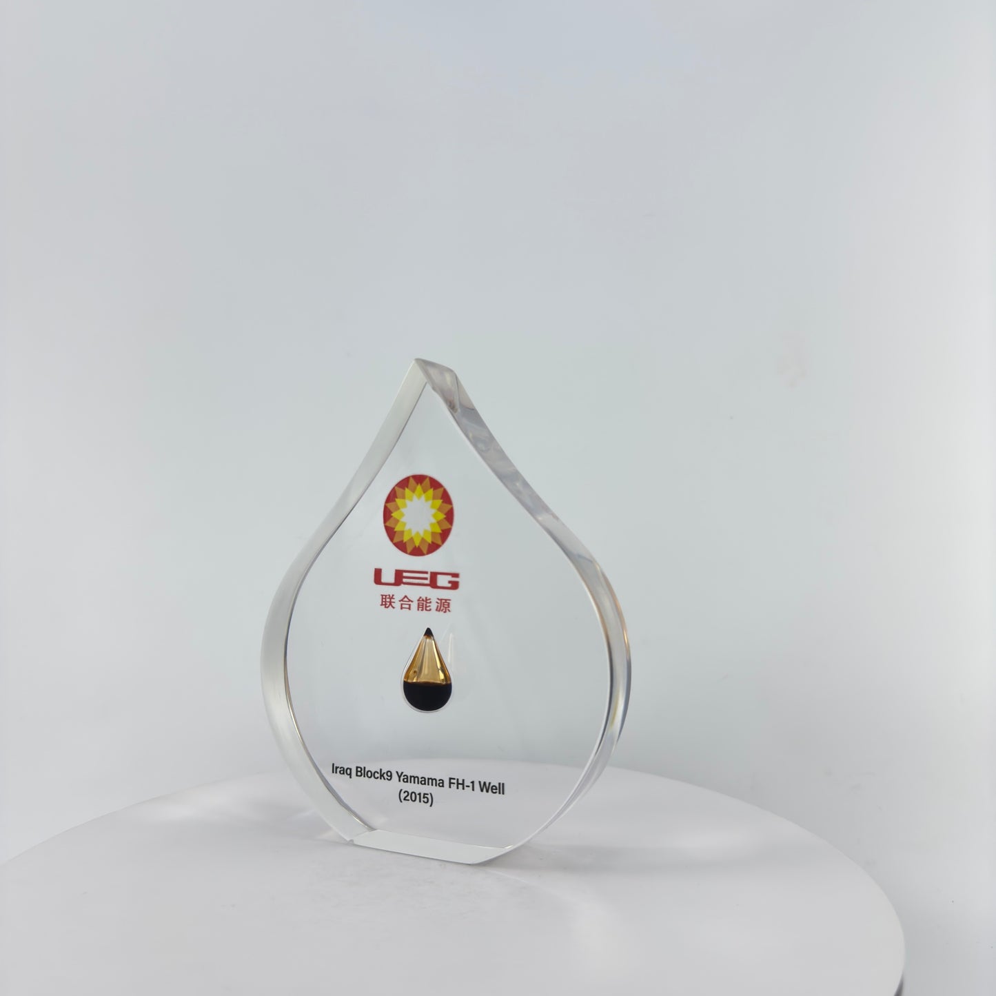 TRANSPARENT PAPER WEIGHT ENCAPSULATED WITH TEAR DROP OIL BOTTLE