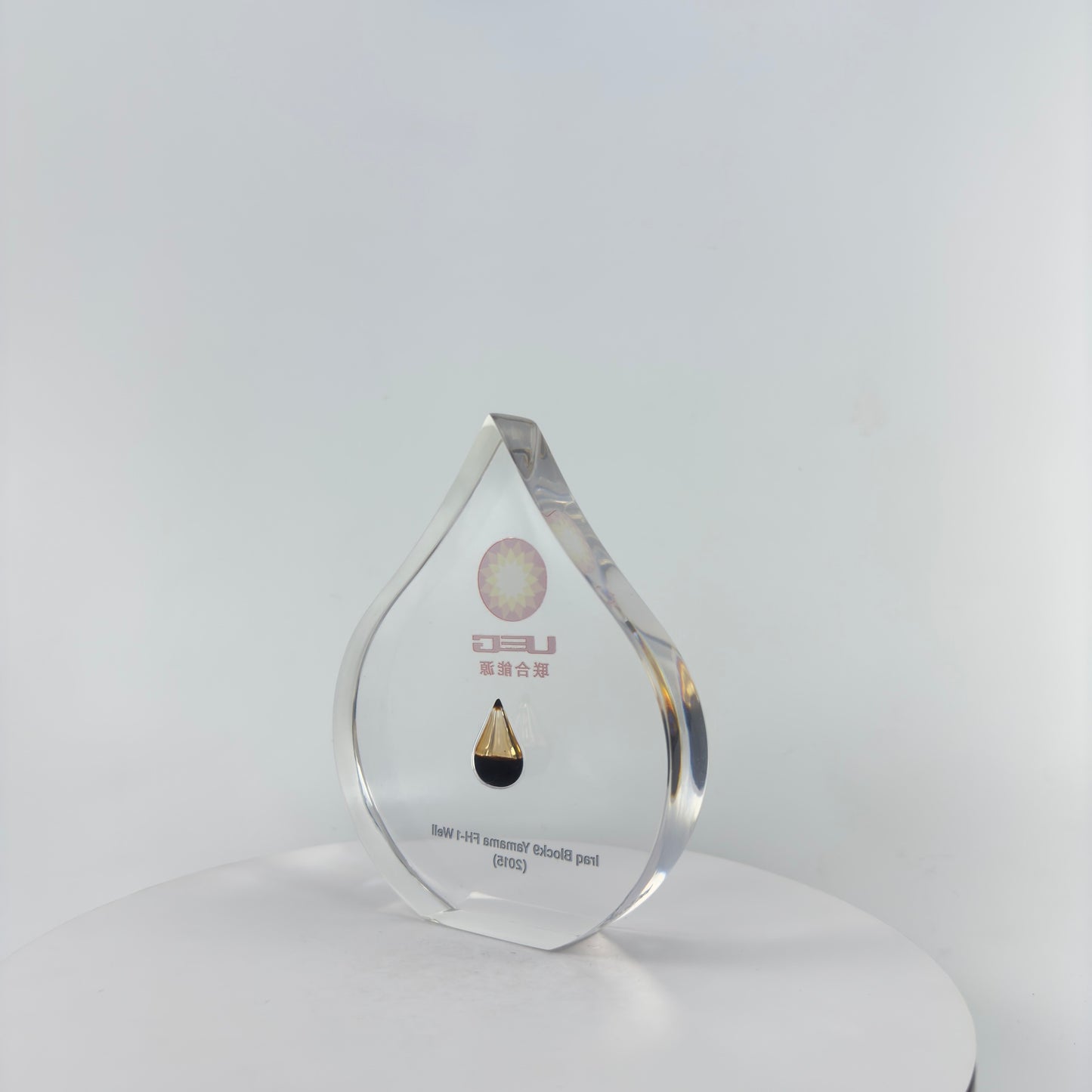 TRANSPARENT PAPER WEIGHT ENCAPSULATED WITH TEAR DROP OIL BOTTLE
