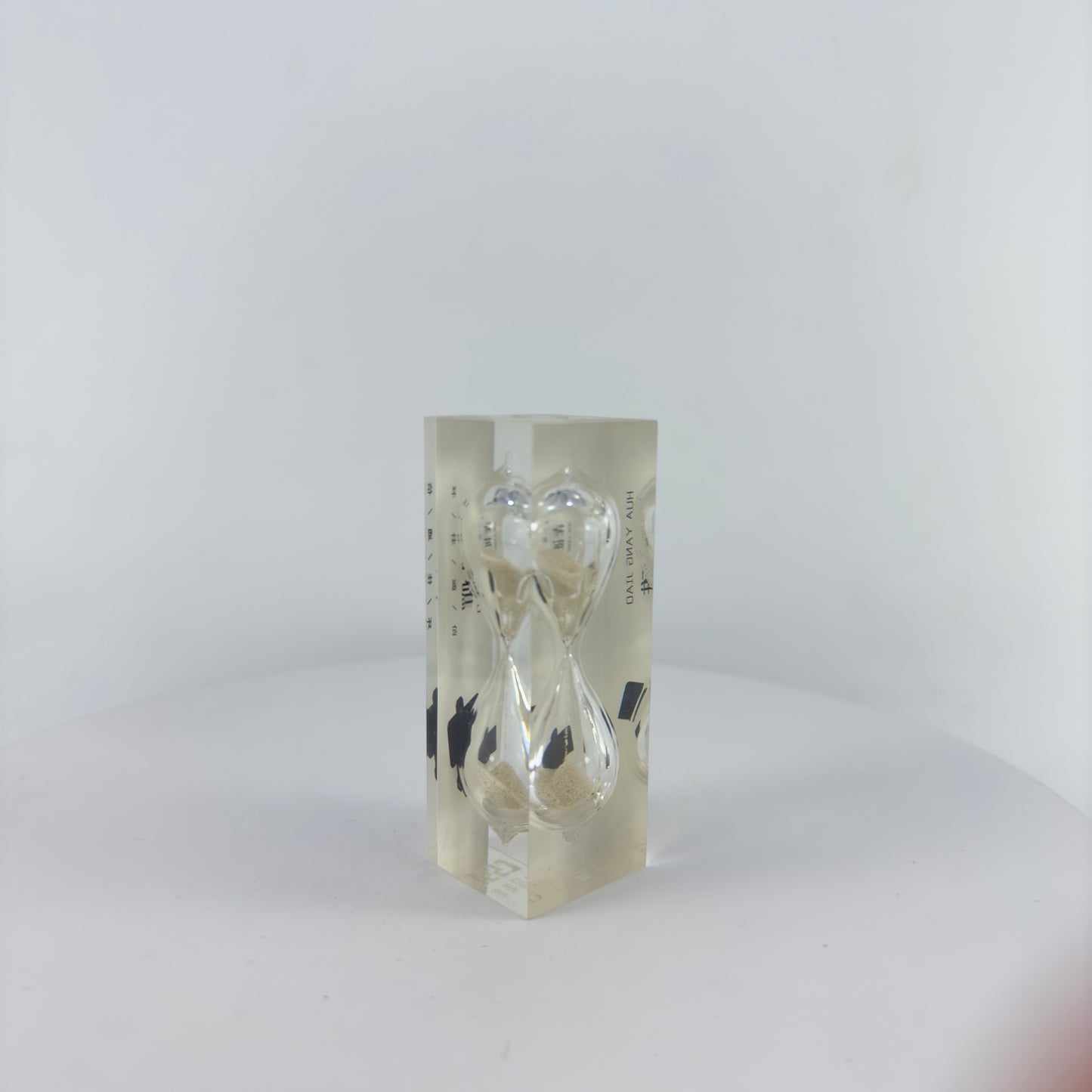 SMALL SAND TIMER ENCAPSULATED INTO TRANSPARENT RESIN