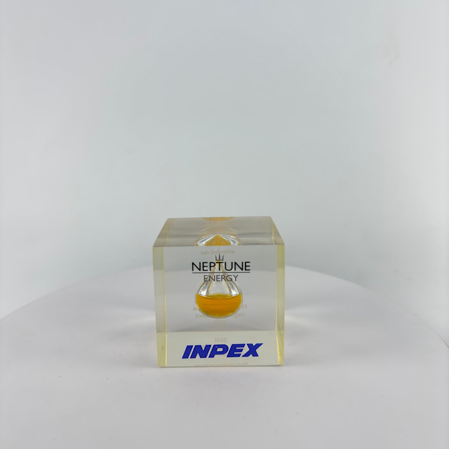 TRANSPARENT PAPER WEIGHT ENCAPSULATED WITH TEAR DROP OIL BOTTLE
