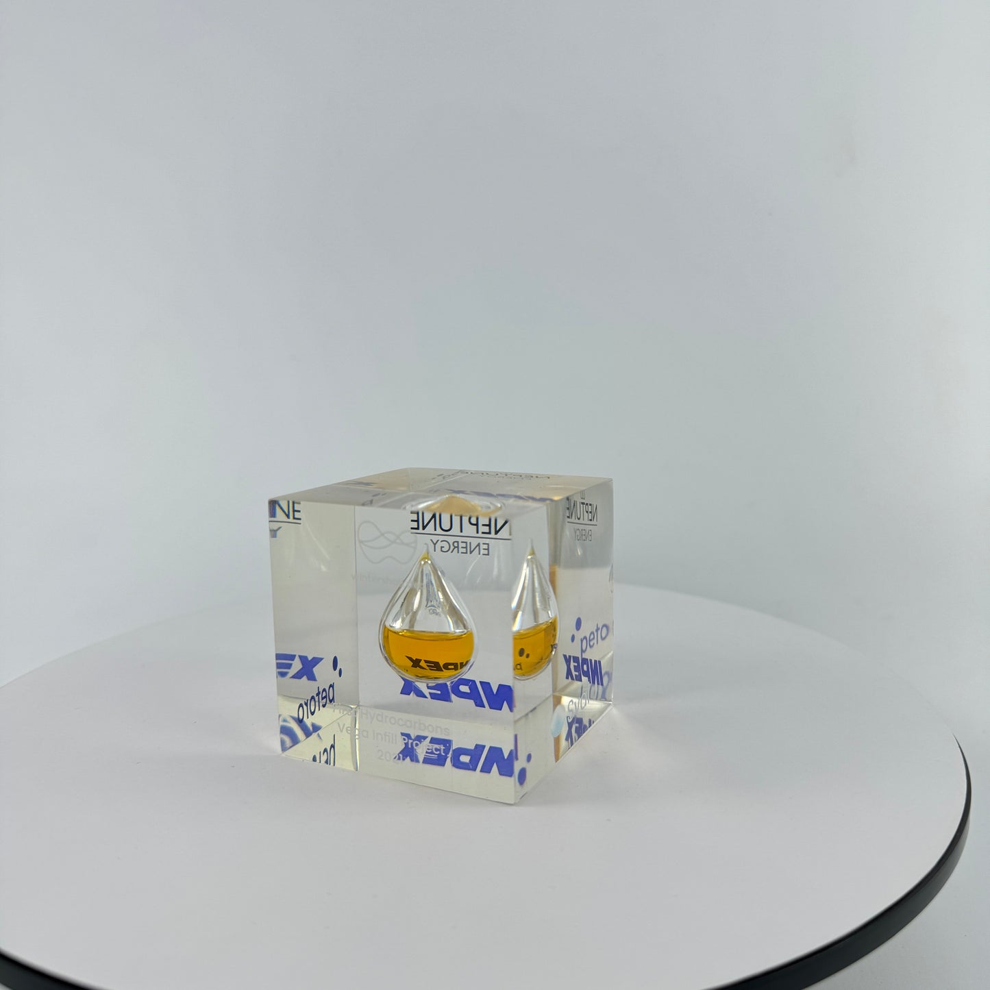 TRANSPARENT PAPER WEIGHT ENCAPSULATED WITH TEAR DROP OIL BOTTLE